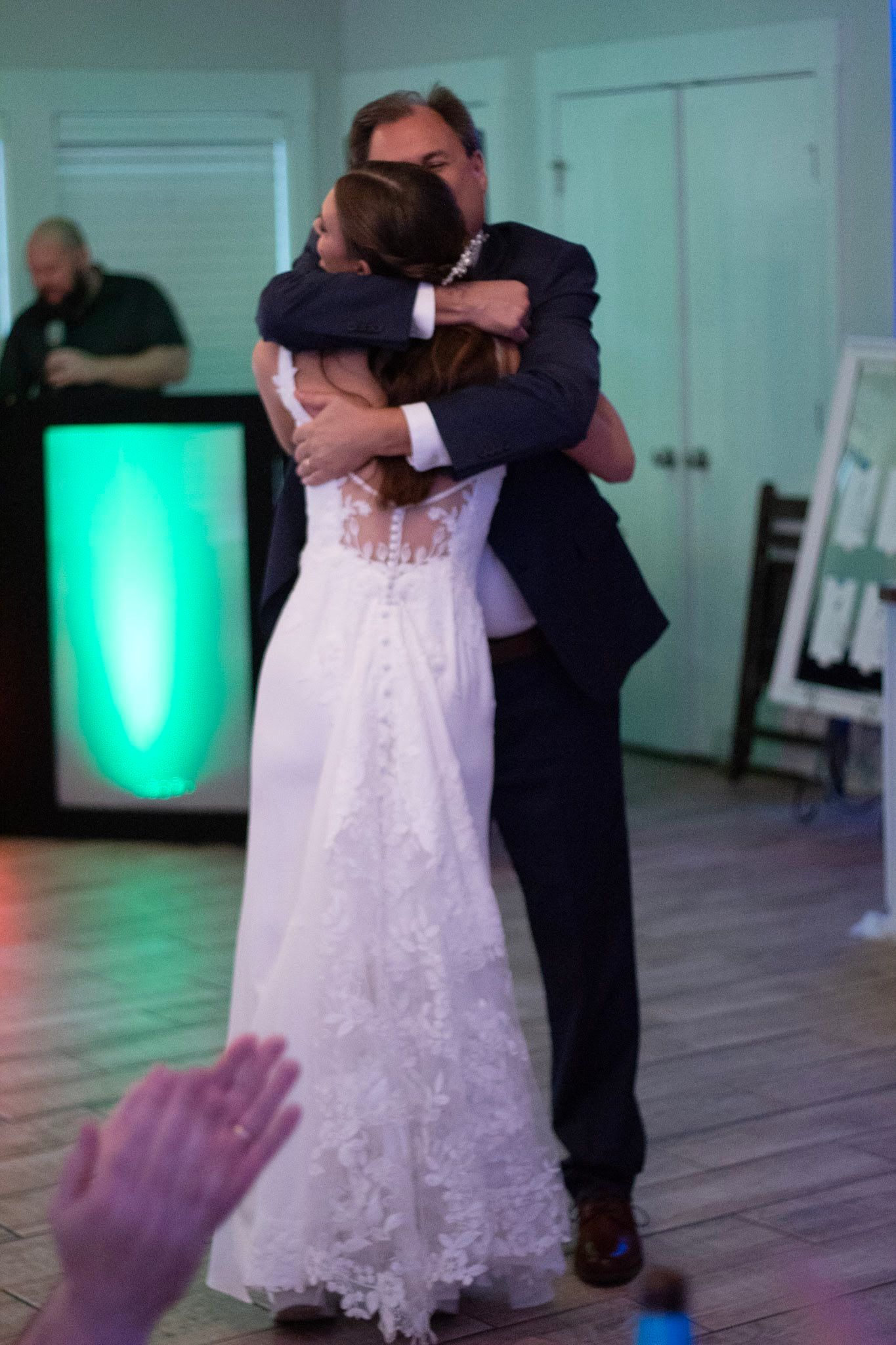 Bride sharing an emotional embrace with her father during father-daughter dance at reception.