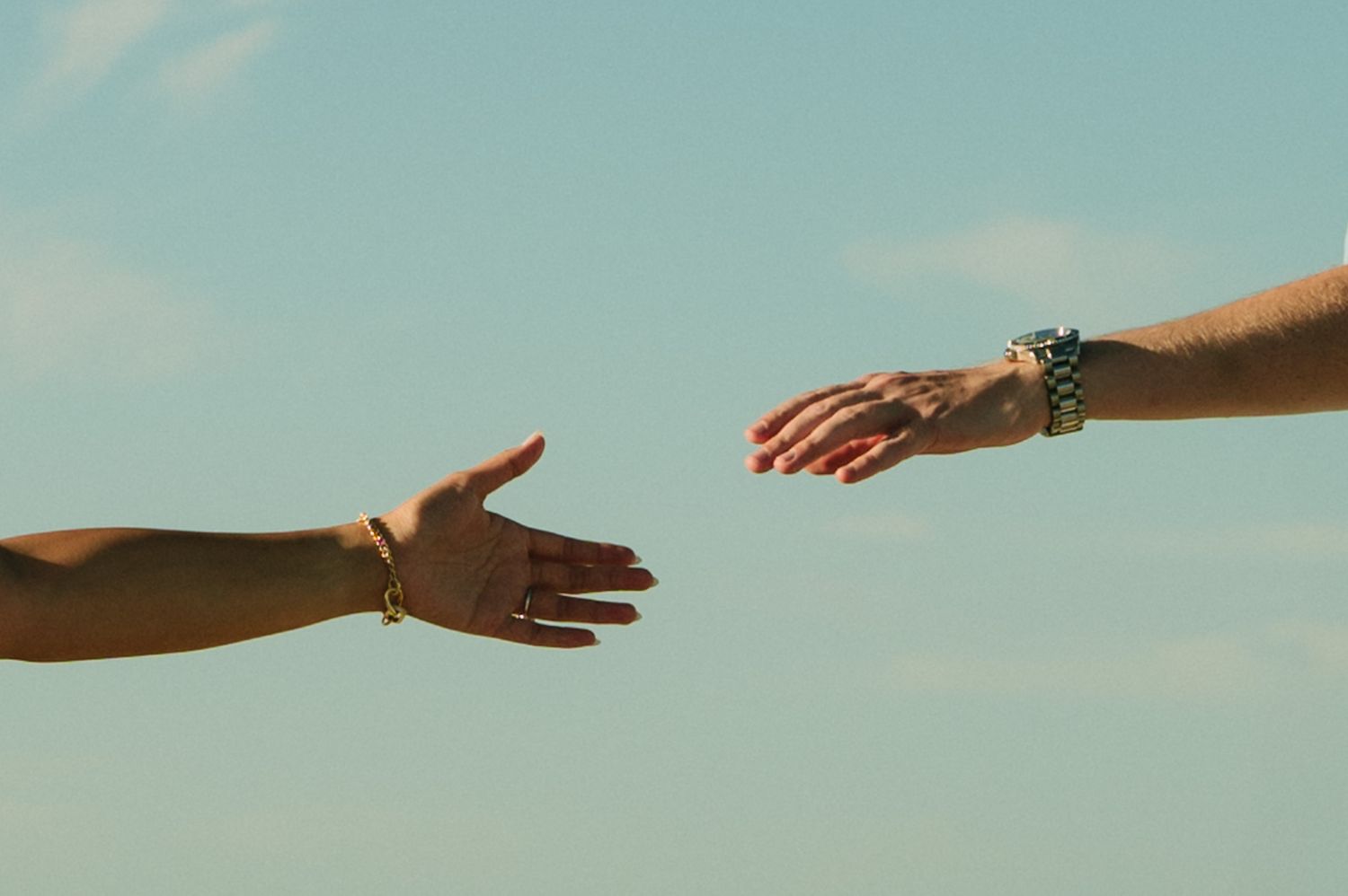 hands reaching out to each other lovingly at vilano beach, st. augustine.