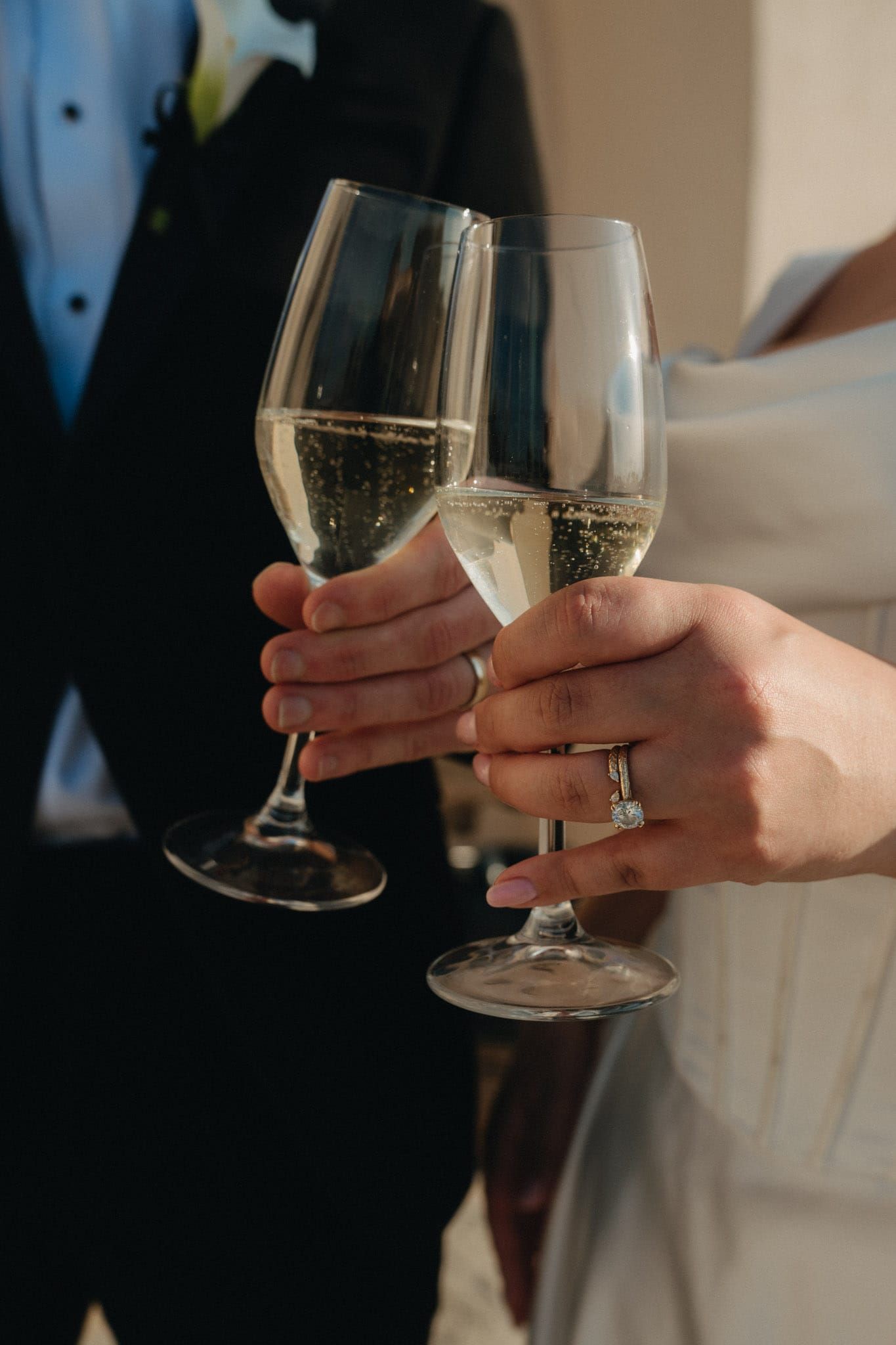 Editorial wedding detail photo of a bride and groom celebrating with a luxury champagne toast in North Florida.
