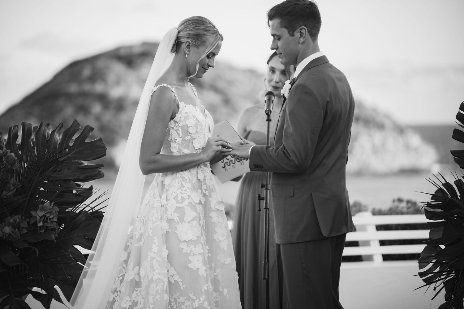 Black and white wedding photos showing intimate moments between newlyweds against scenic outdoor backdrops.