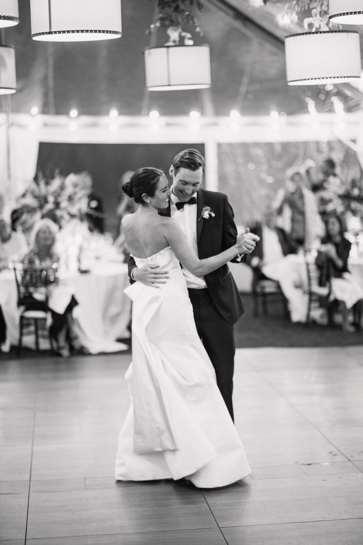 A romantic black and white wedding dance sequence showing multiple angles of a couple dancing together at their reception.