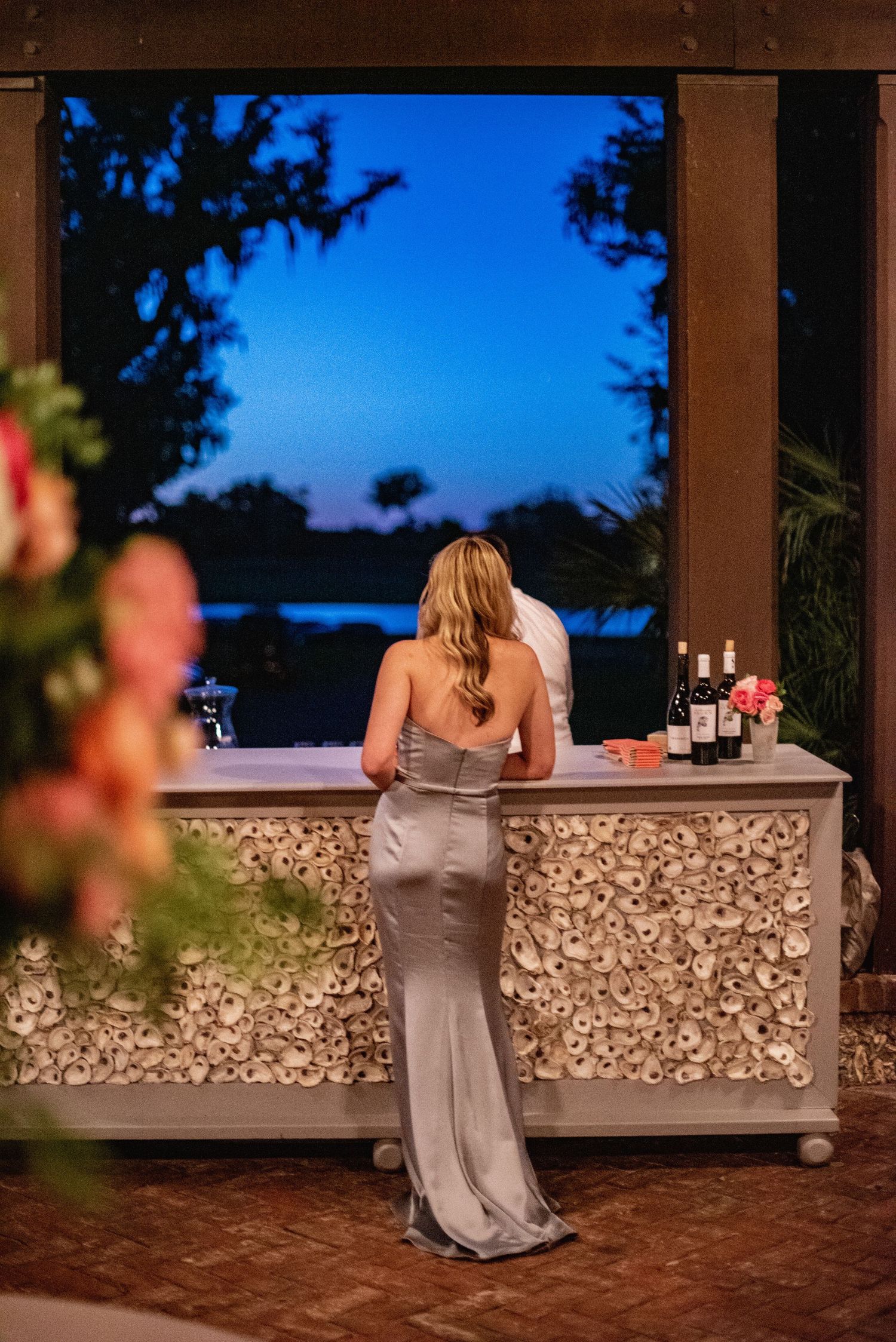 A sequence of wedding photos showing a bride in a champagne dress leaning on a stone wall at sunset.