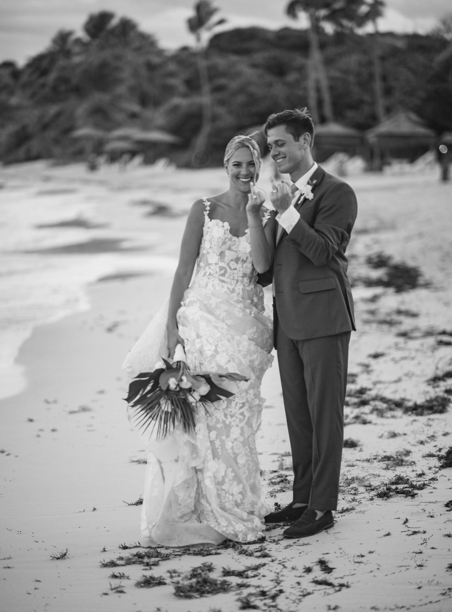 A romantic black and white series of photos showing a couple walking and embracing on a beach.