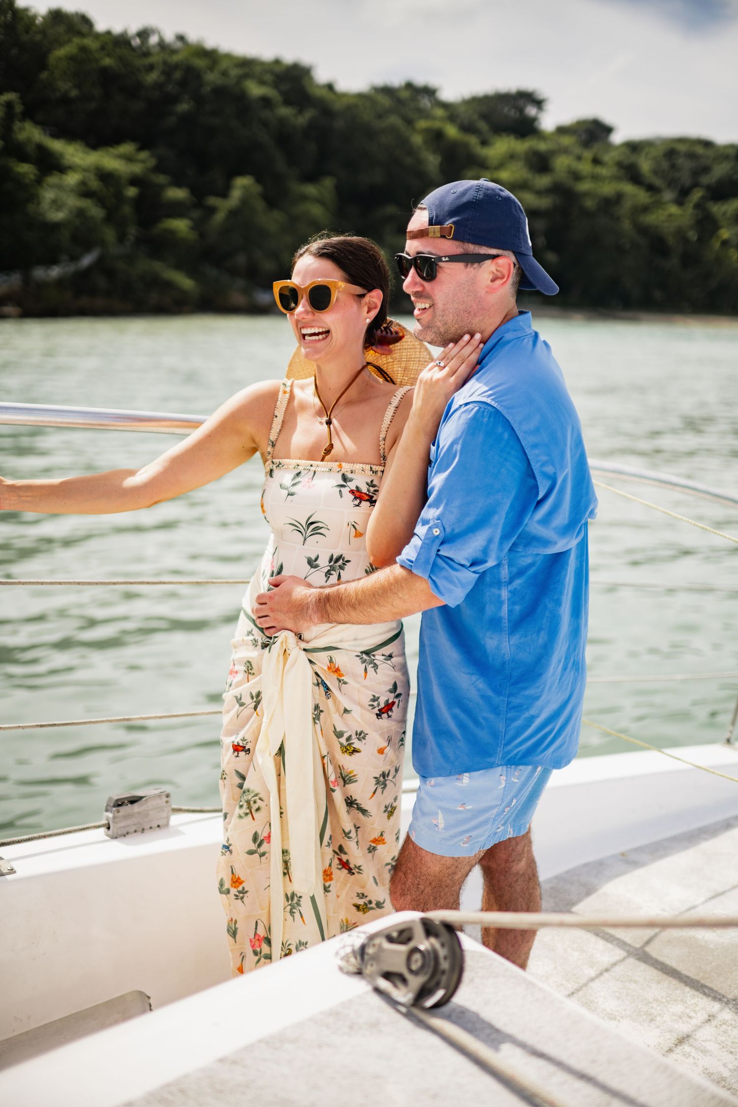 Couple enjoying a romantic day on a boat while cruising along calm waters on a sunny afternoon.