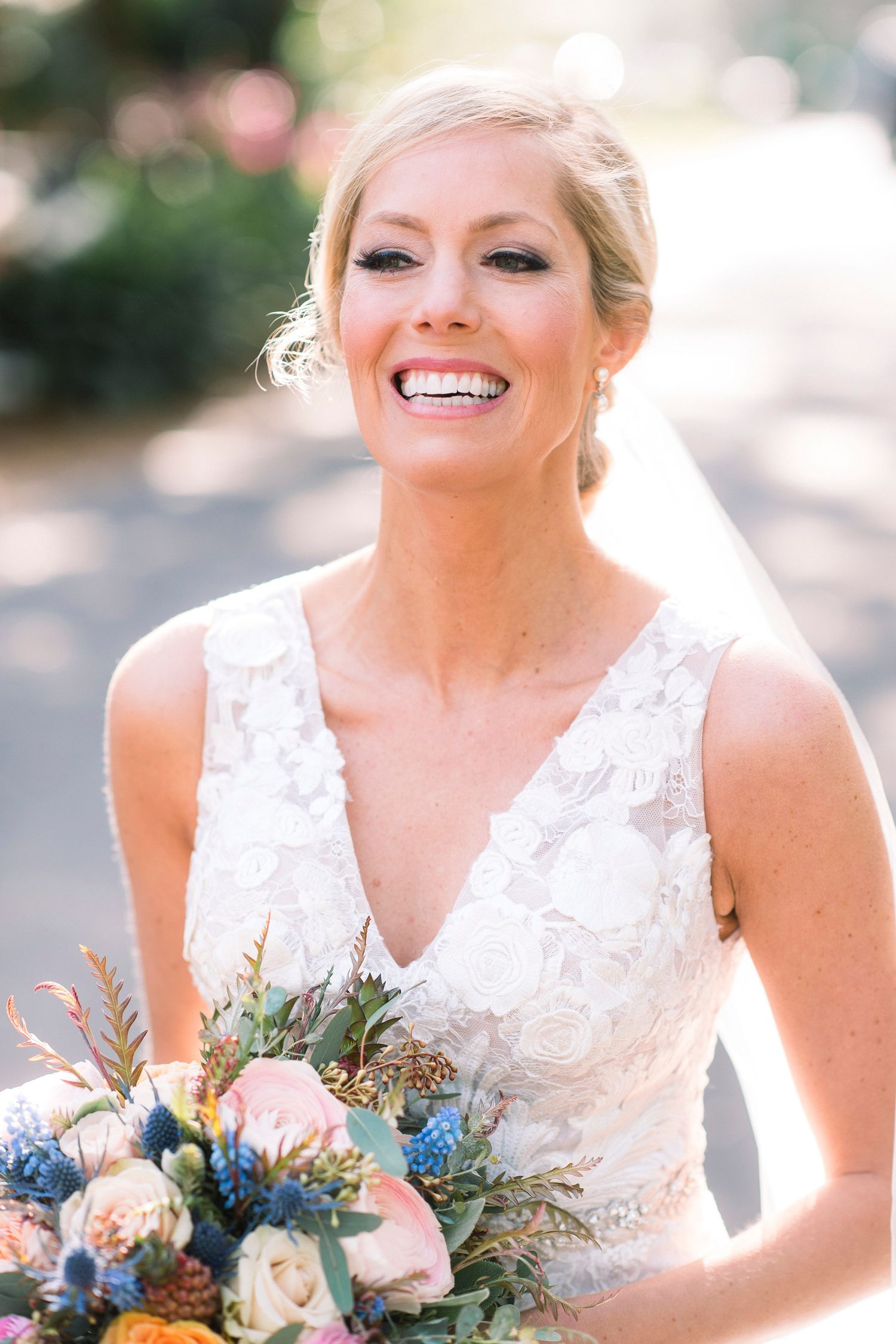 Progressive close-up shots of a radiant bride holding a blue and white floral bouquet.