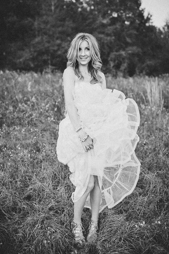 A series of black and white photos showing someone in a flowing white dress twirling and dancing in a grassy meadow.