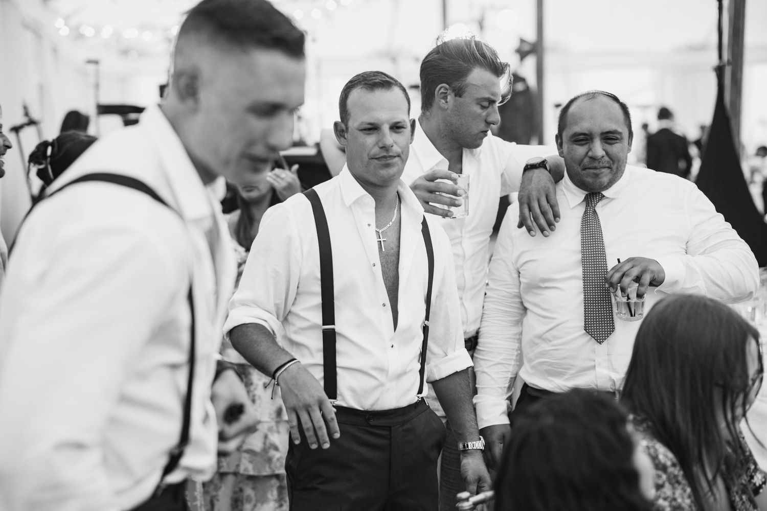 Wedding guests mingling and dancing at an elegant outdoor reception.