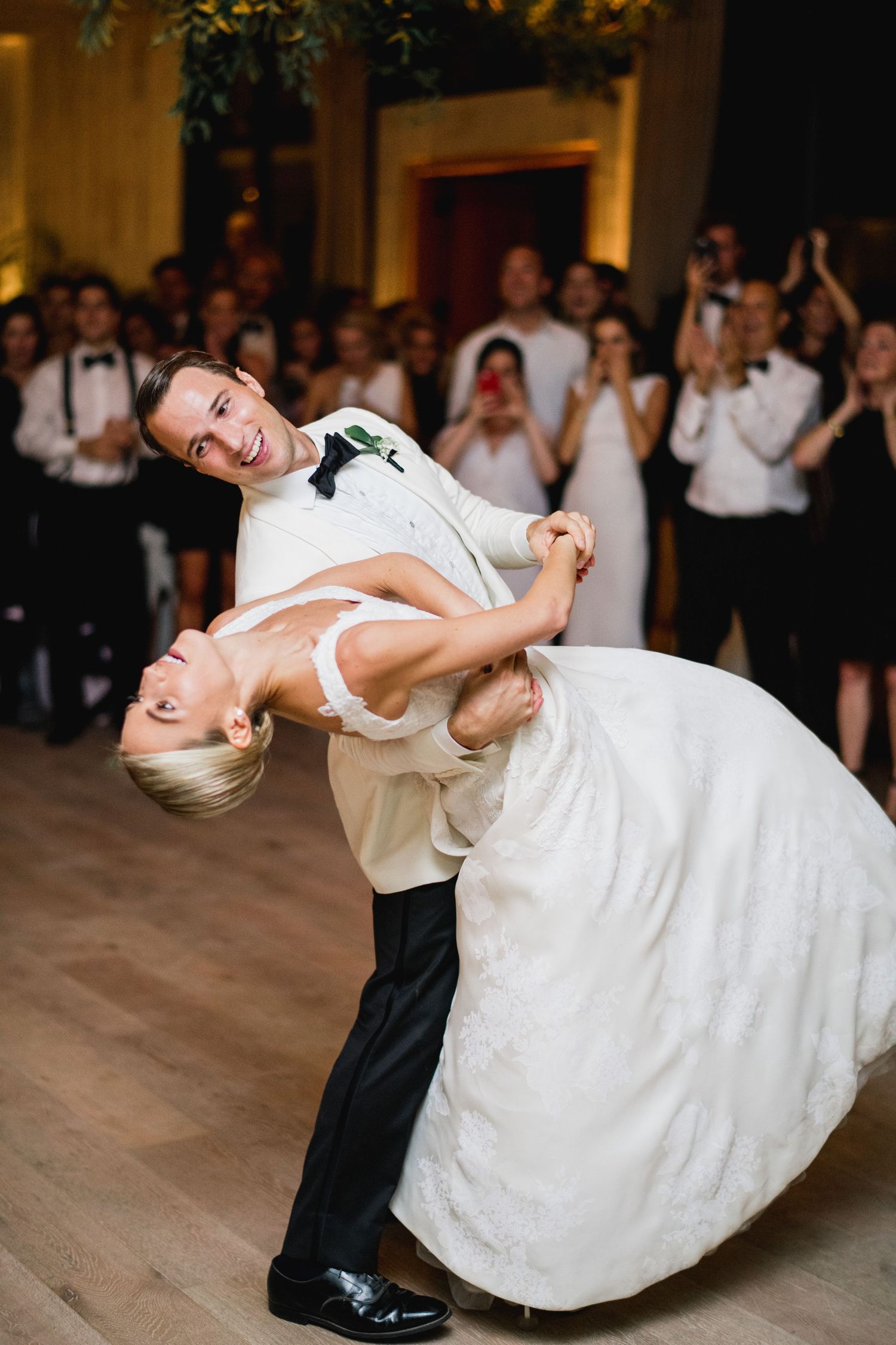 Sequence of dance photos showing a dramatic dip move during a wedding first dance on a wooden dance floor.