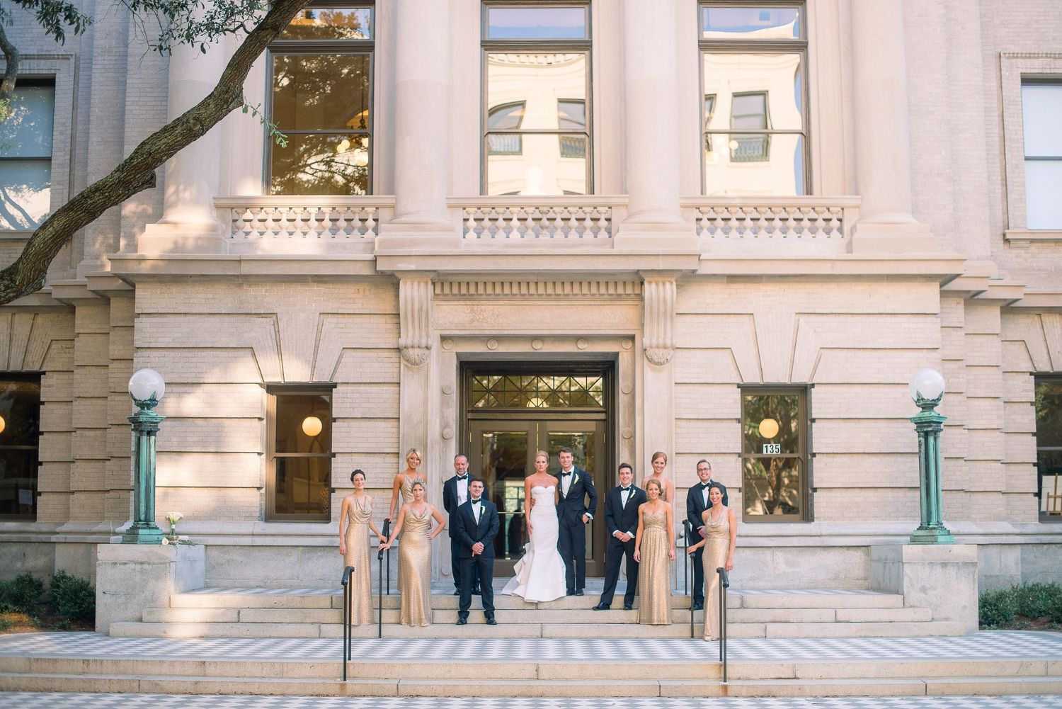 A classical stone building entrance with ornate columns and stairs leading to double doors.