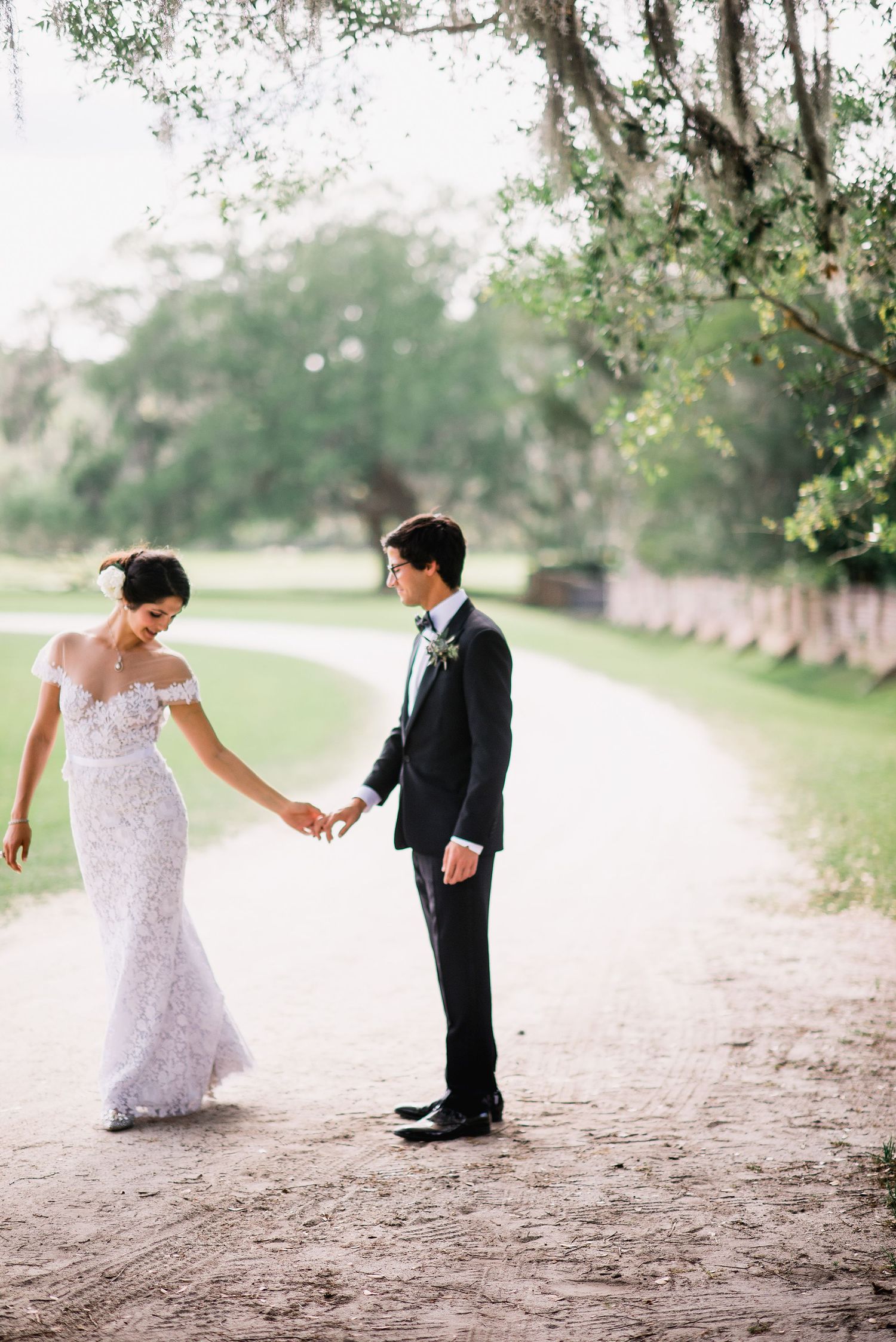 A romantic sequence of wedding photos showing a couple dancing playfully on a tree-lined path.