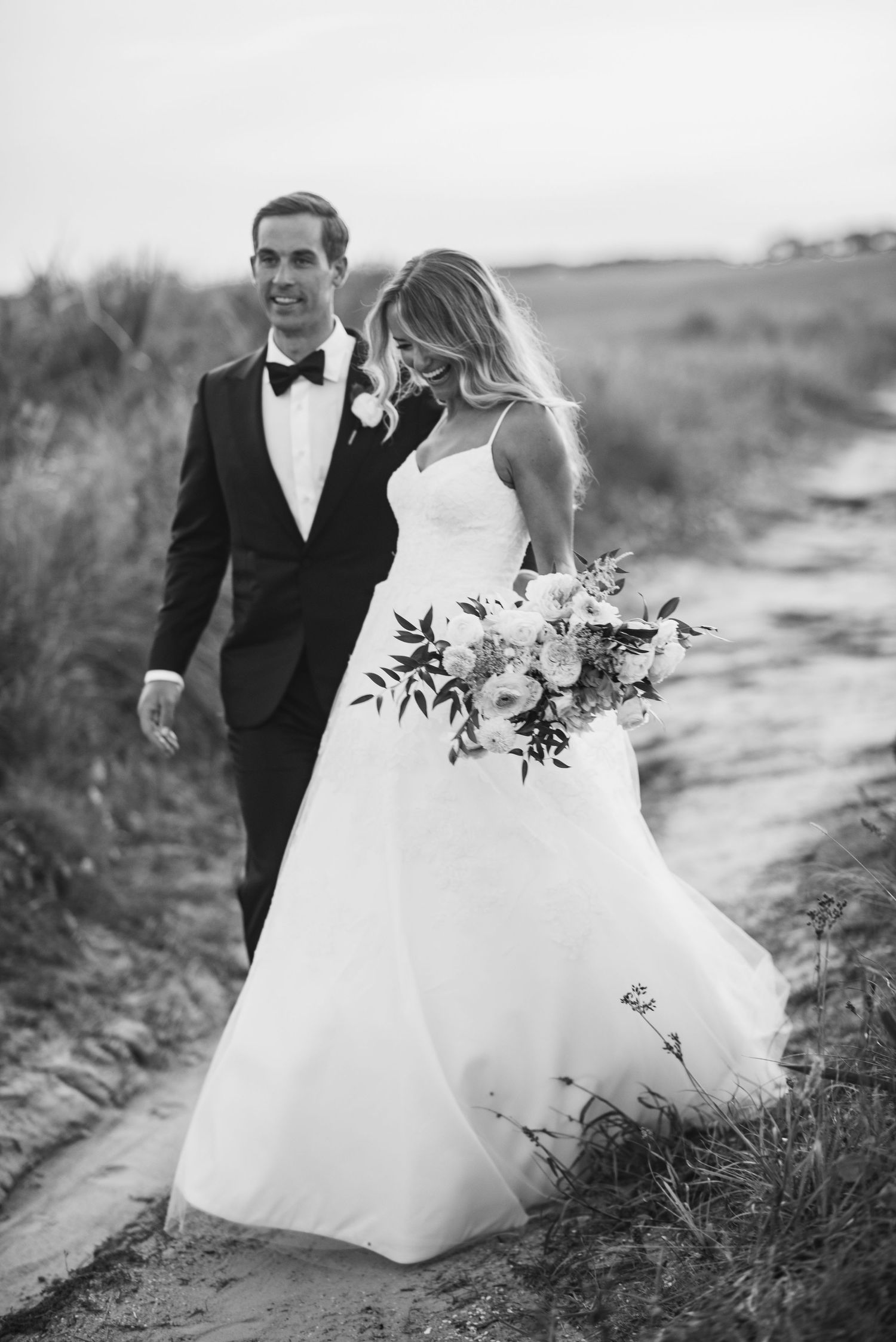 A black and white wedding photo series showing a couple running playfully through a field with the bride's dress flowing.