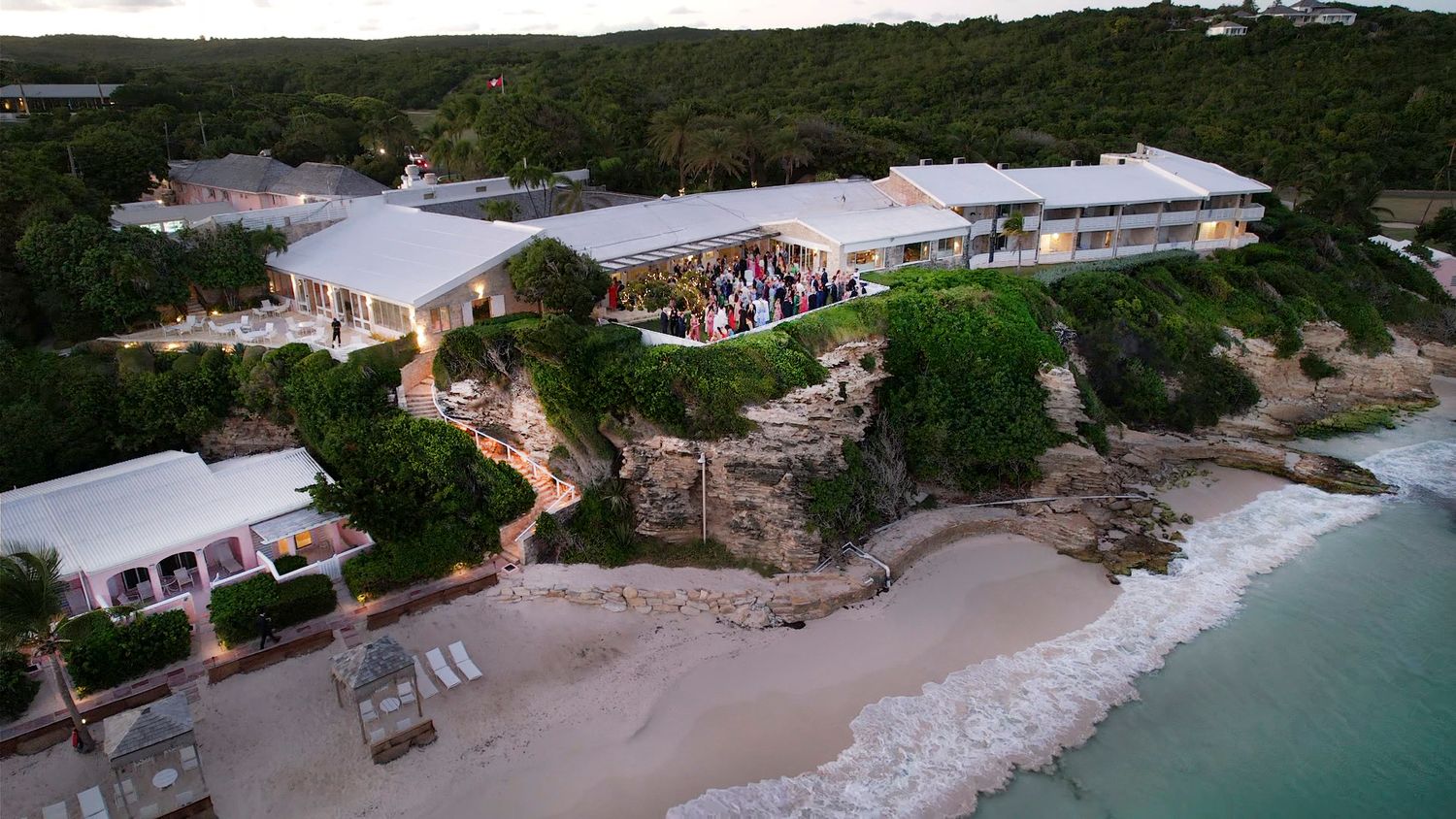 Drone shot of beachfront properties along a tropical coastline with sandy beaches.