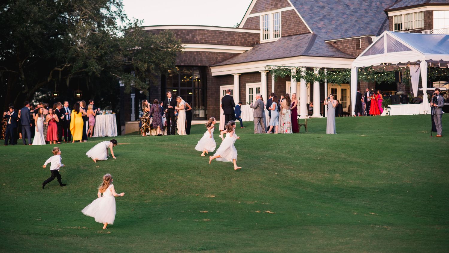 A series of outdoor wedding celebration photos showing guests mingling on a green lawn near a white building.
