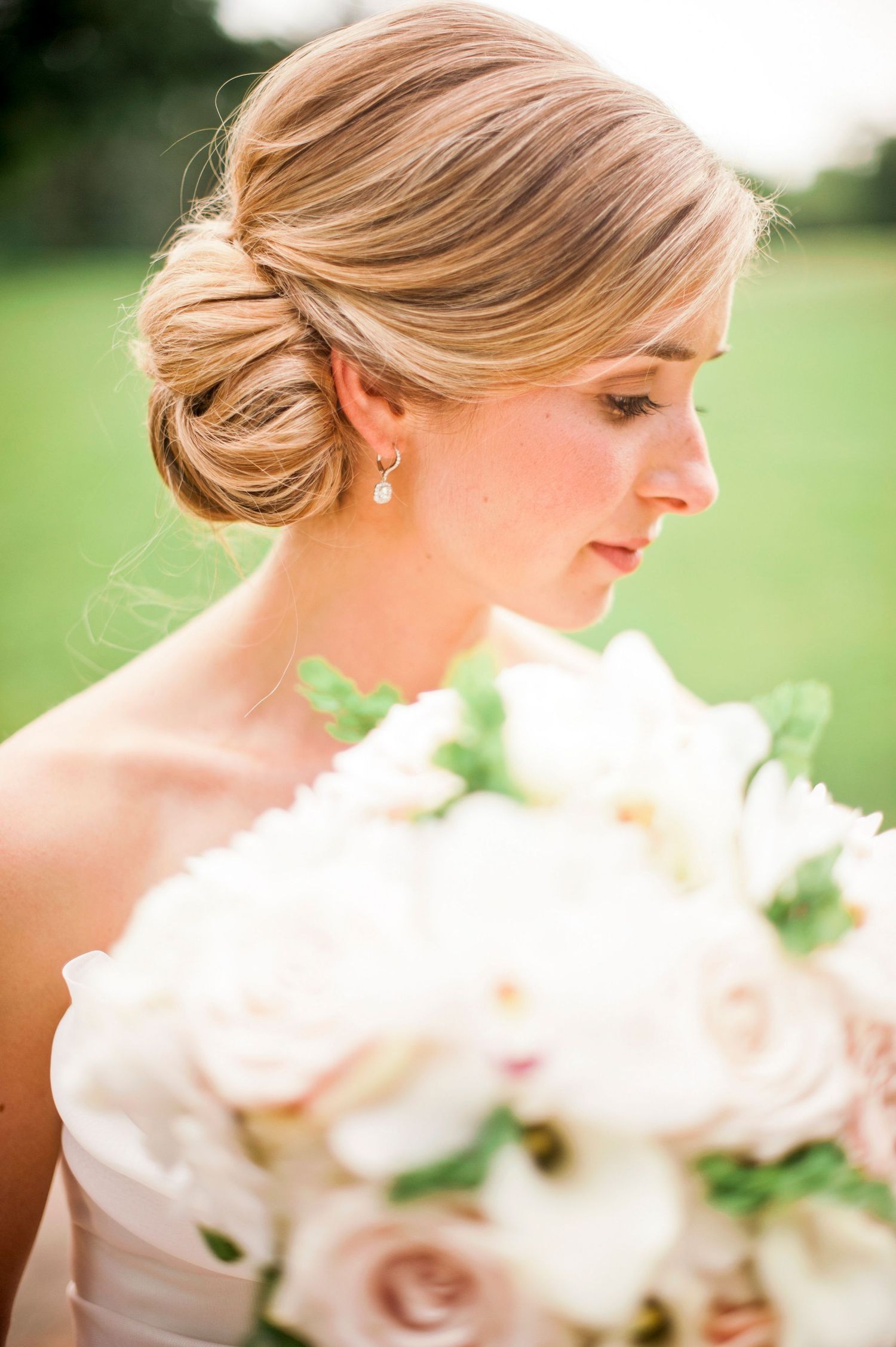 Delicate white flowers in a bridal bouquet with soft focus and natural lighting.
