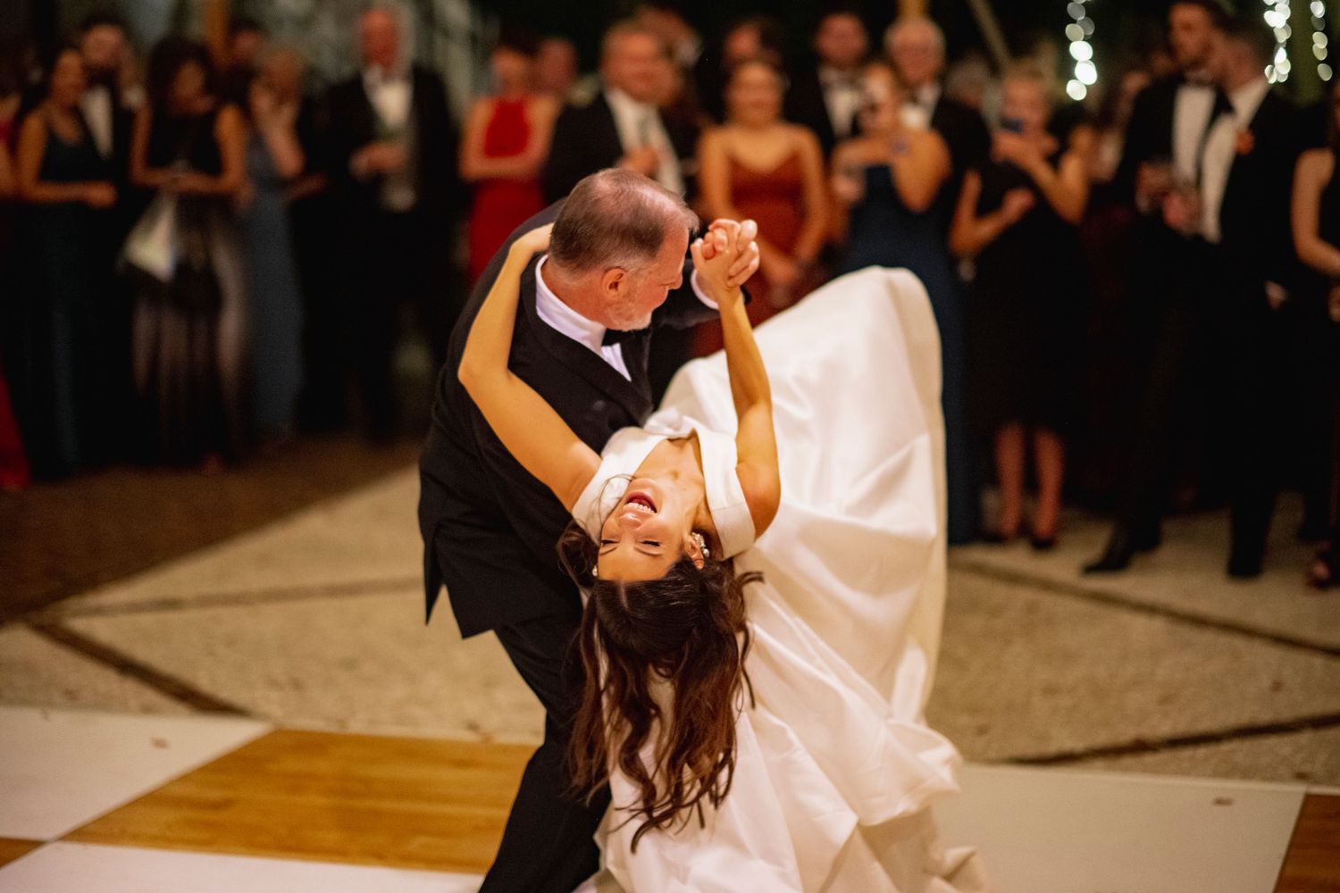 Couples dancing together during an elegant evening wedding reception celebration.