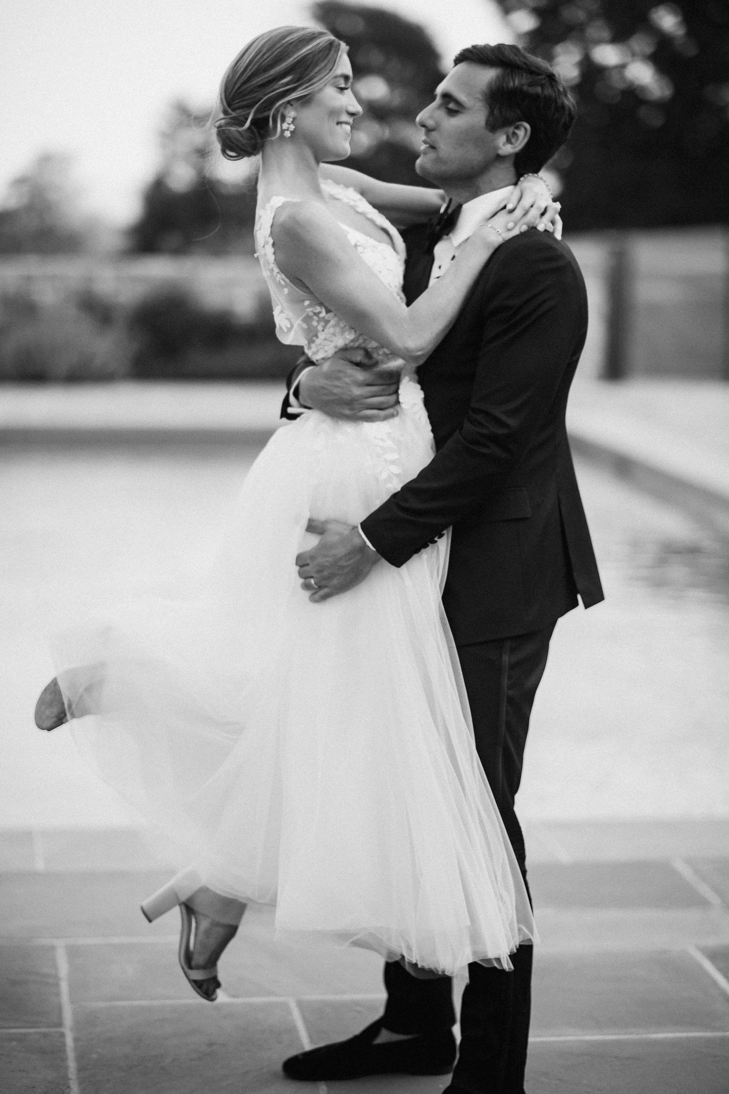 Black and white sequence of romantic dance moves between newlyweds.