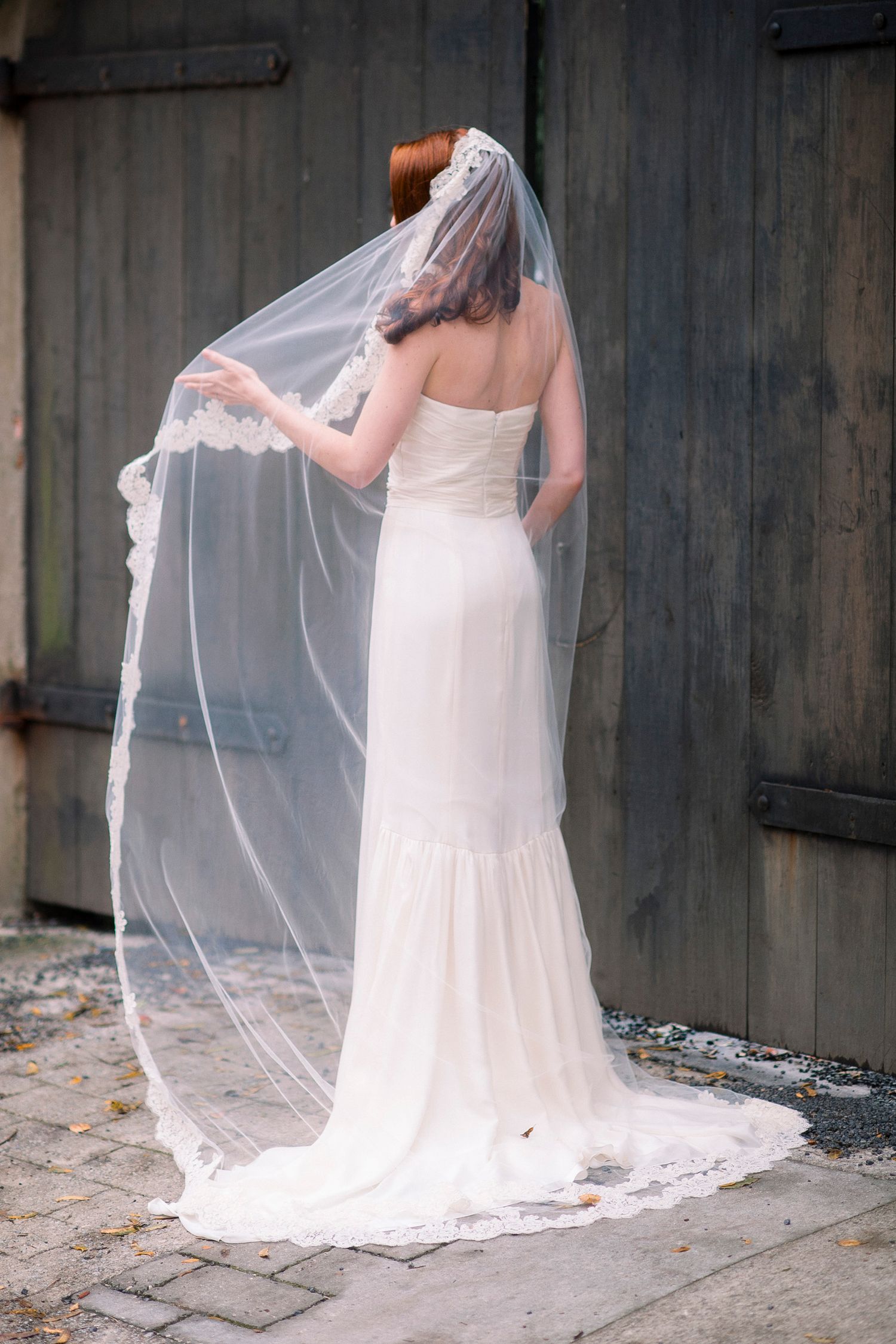 A series of wedding photos showing the back of a bride's white dress and flowing veil against a concrete wall.