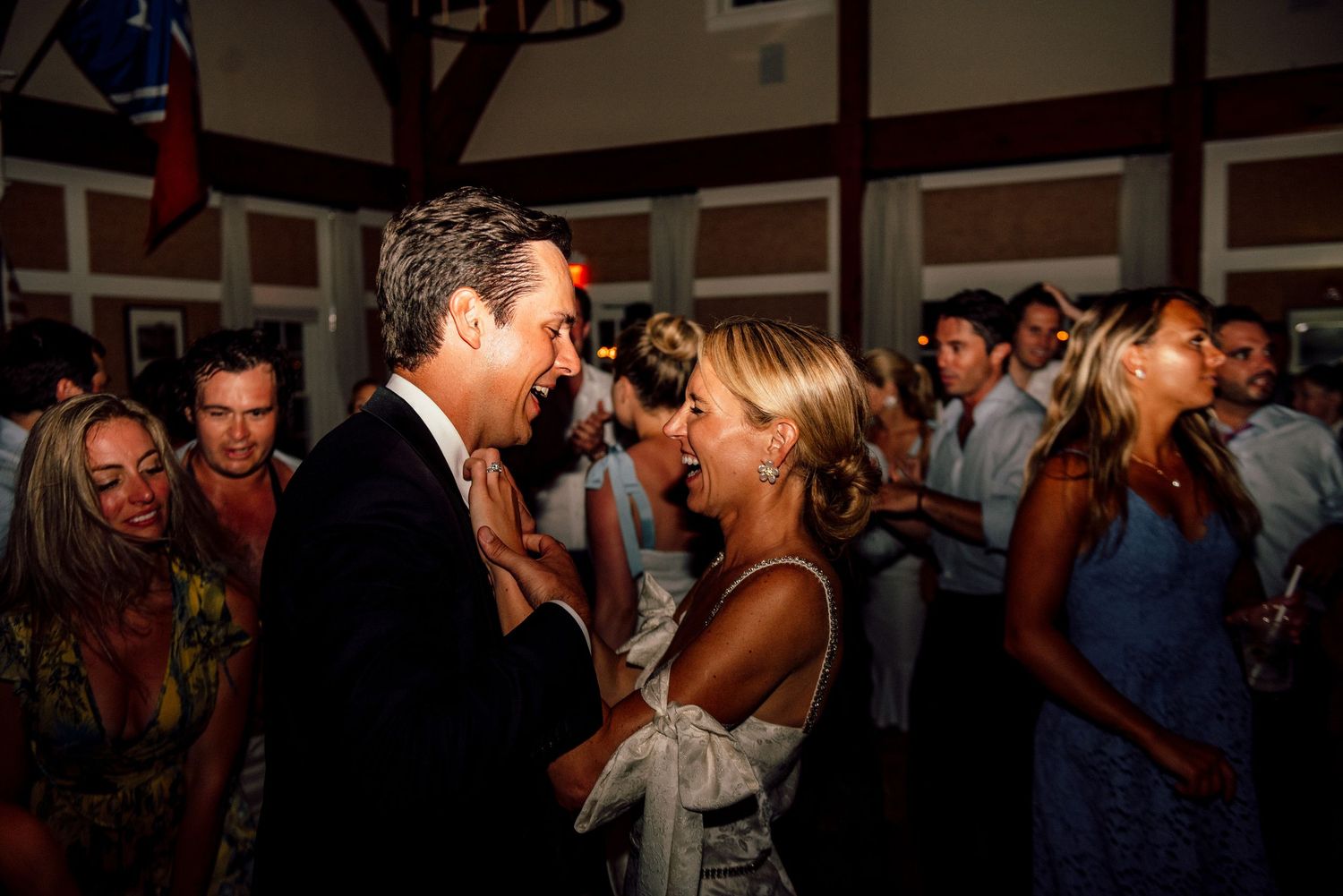 Wedding reception dance floor filled with celebrating guests in formal attire.
