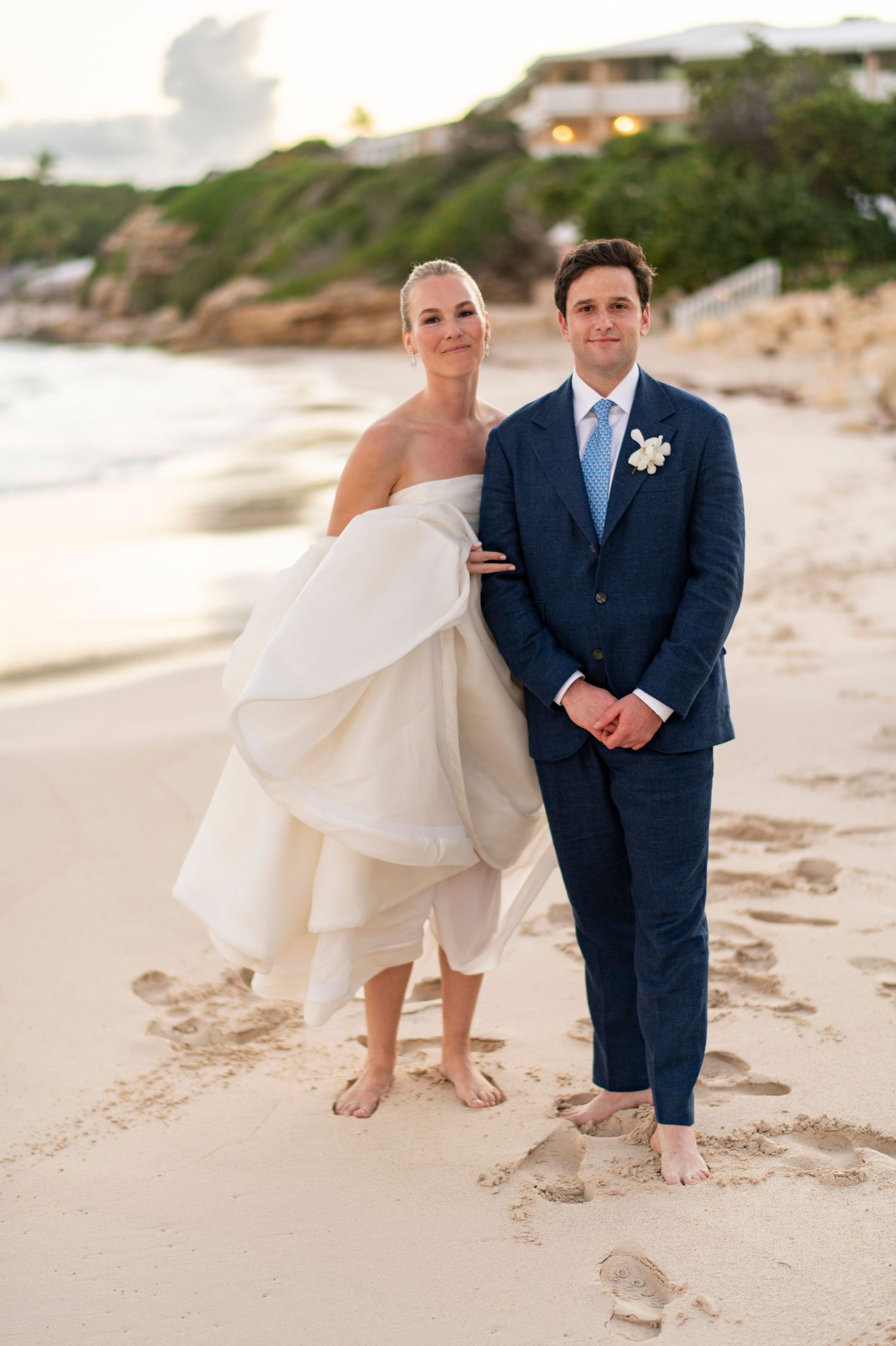 Close-up shots of feet in the sand during a beach wedding photoshoot.