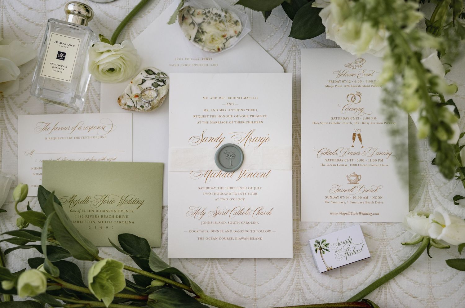 Elegant wedding stationery suite featuring ivory paper, gold calligraphy, and delicate floral details.