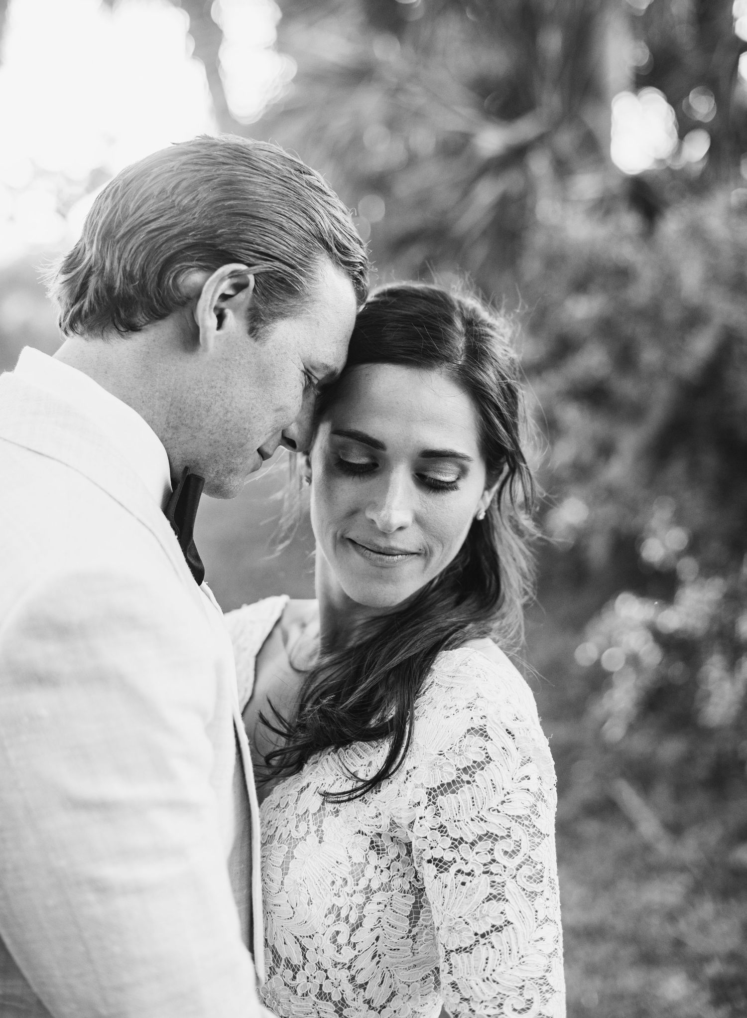 A romantic black and white photo series showing tender moments between a couple in white lace and formal attire.
