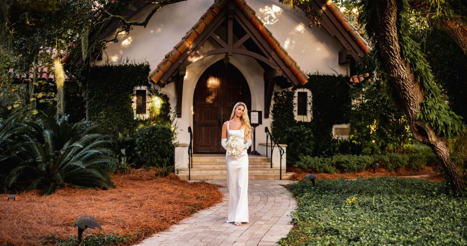 A charming garden wedding venue with stone paths and lush greenery creates an enchanting outdoor setting.