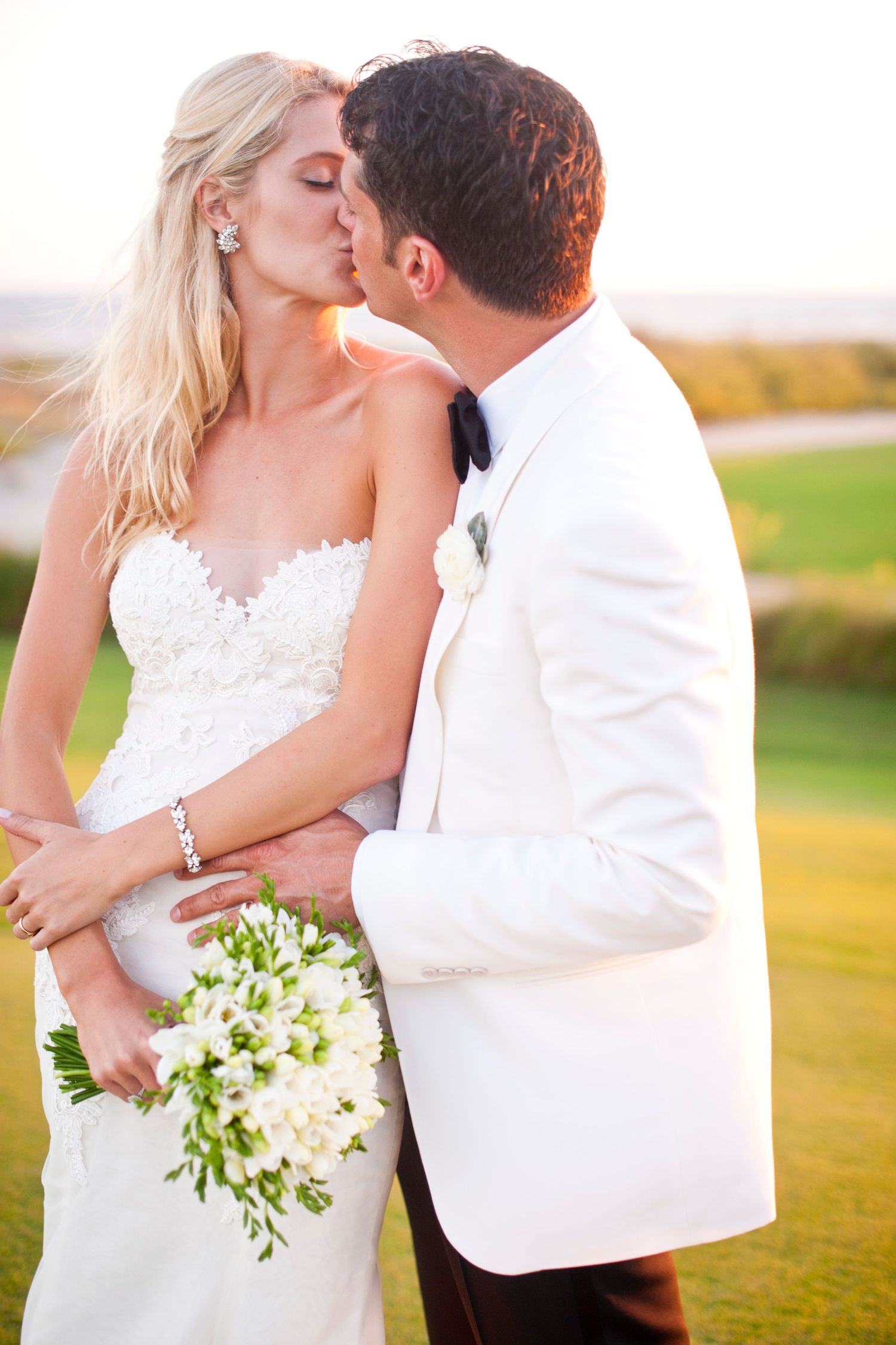 A romantic wedding couple shares intimate kisses in a series of outdoor portraits at sunset.