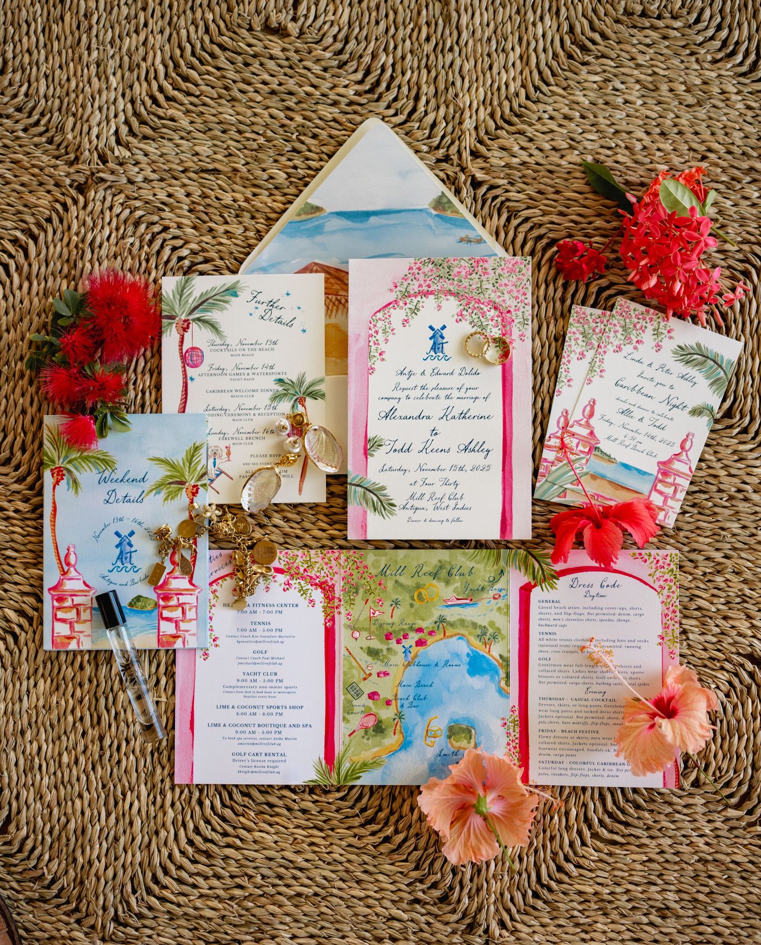 Tropical wedding invitations with red and pink flowers laid out on woven mat.