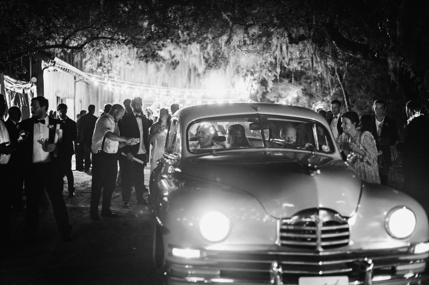 A collection of vintage cars and crowds shown in black and white photographs at a classic car event.