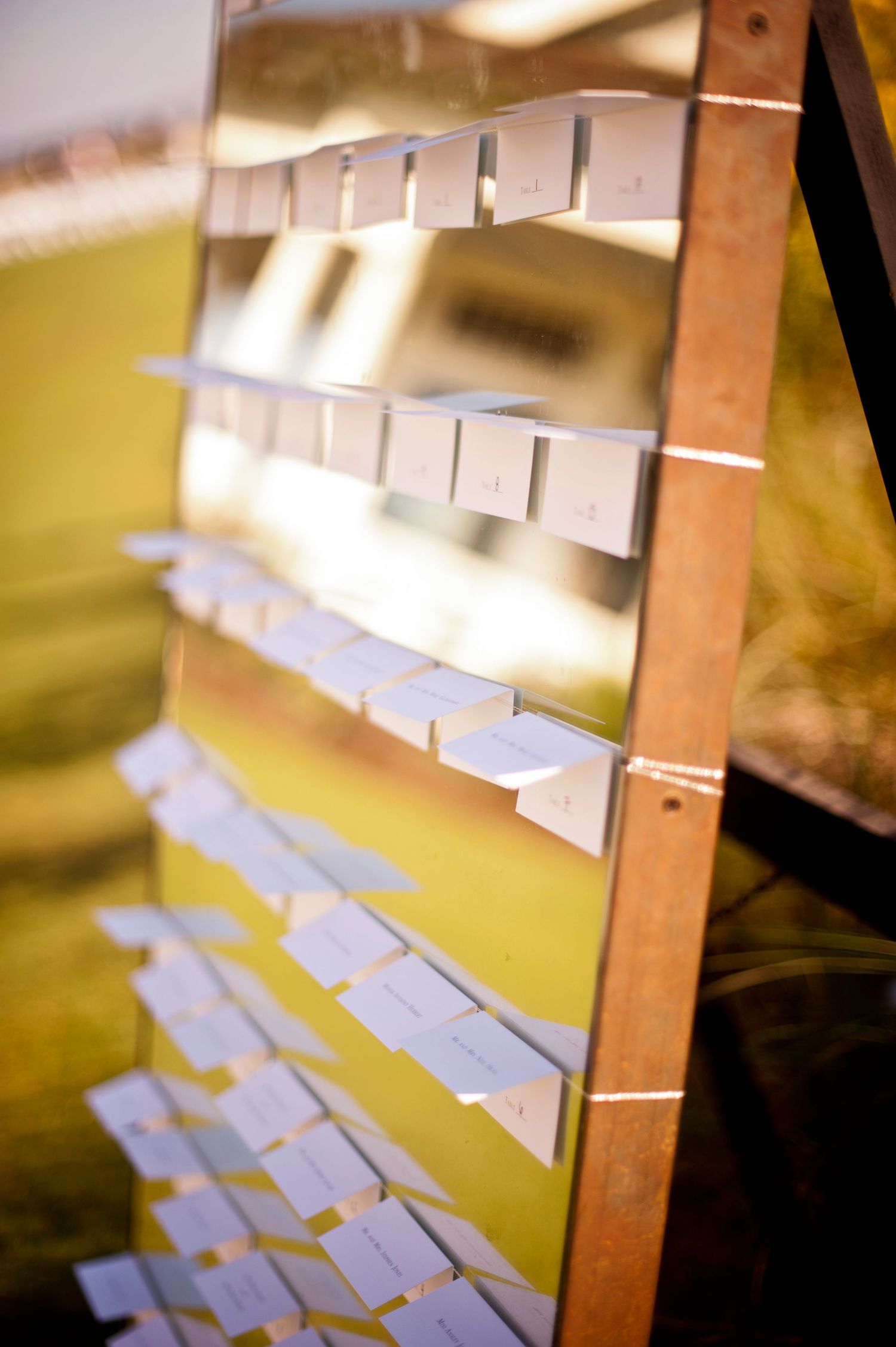 Close-up view of white angular shelving brackets mounted on a wooden beam with soft lighting.