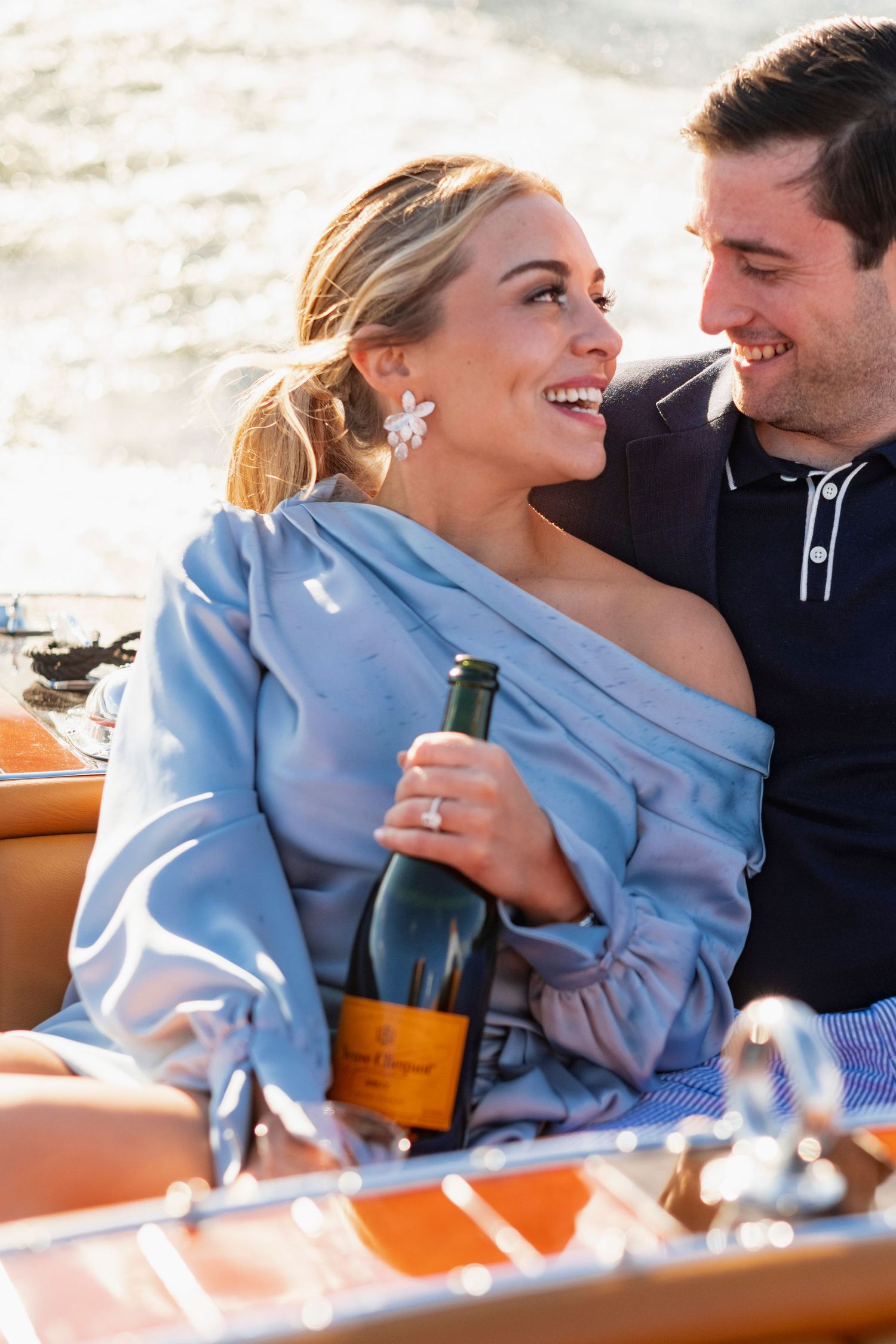A couple shares an intimate moment while sitting together in casual attire.