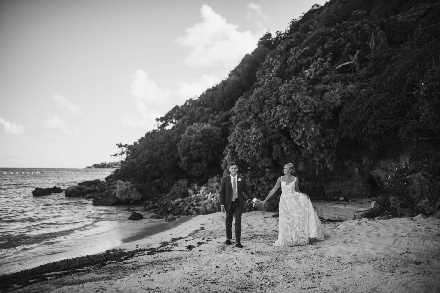 Black and white beach wedding photos with dramatic coastal cliffs and ocean views.
