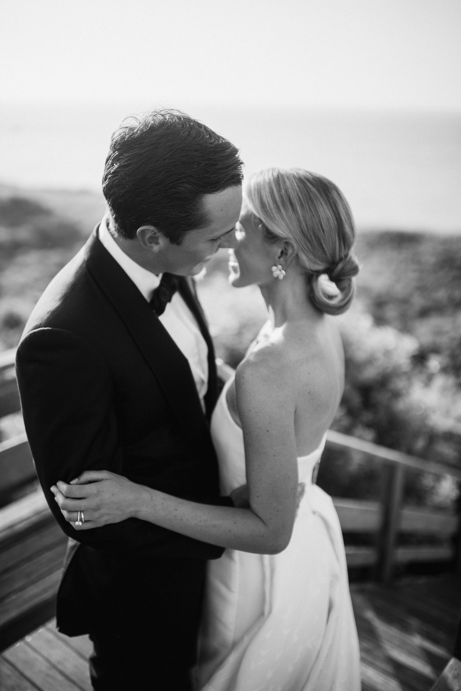 A black and white photo series showing a romantic moment between a couple in formal wedding attire.