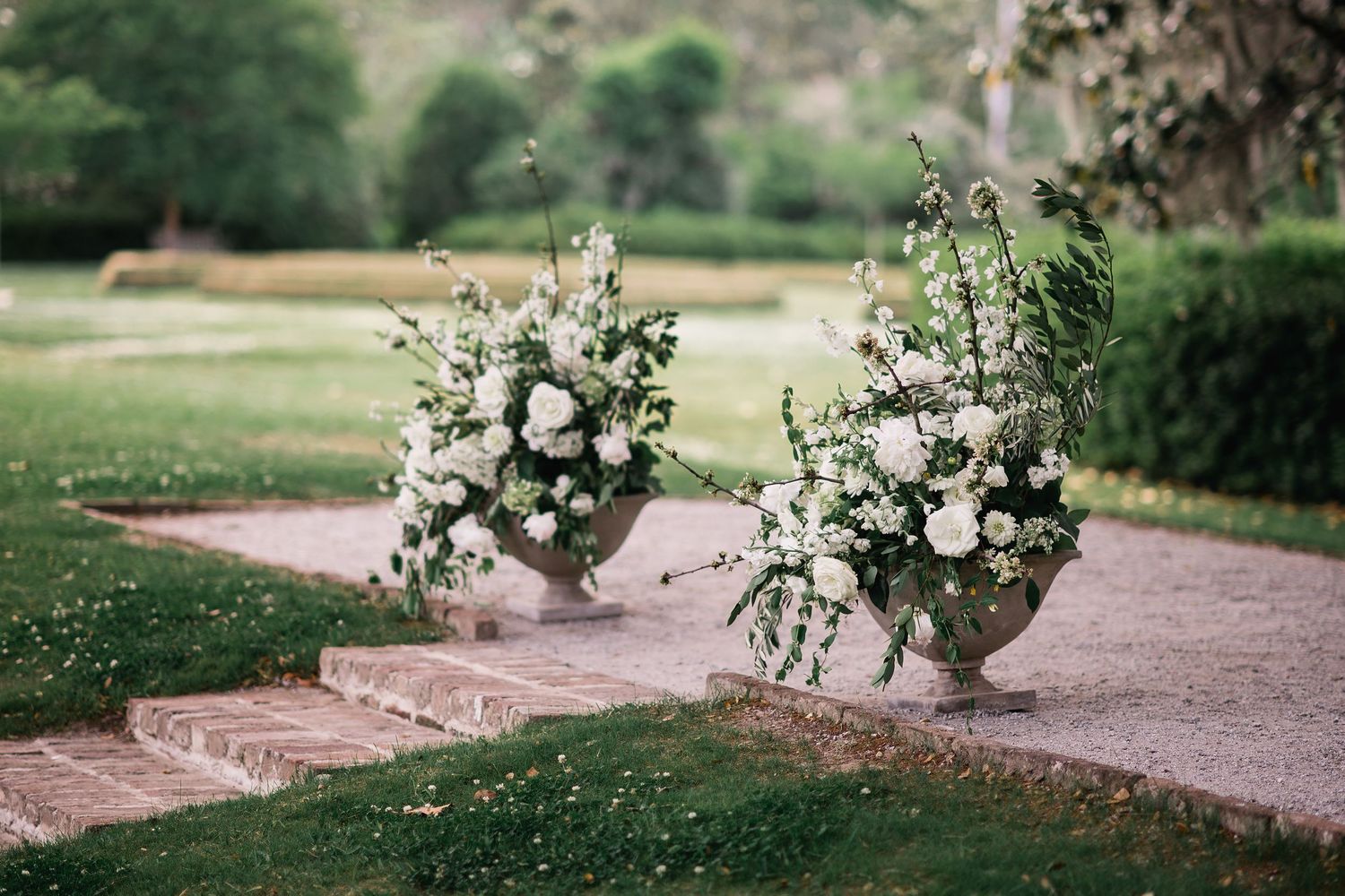 A series of romantic garden wedding photos showing floral arrangements and brick pathways in an outdoor setting.
