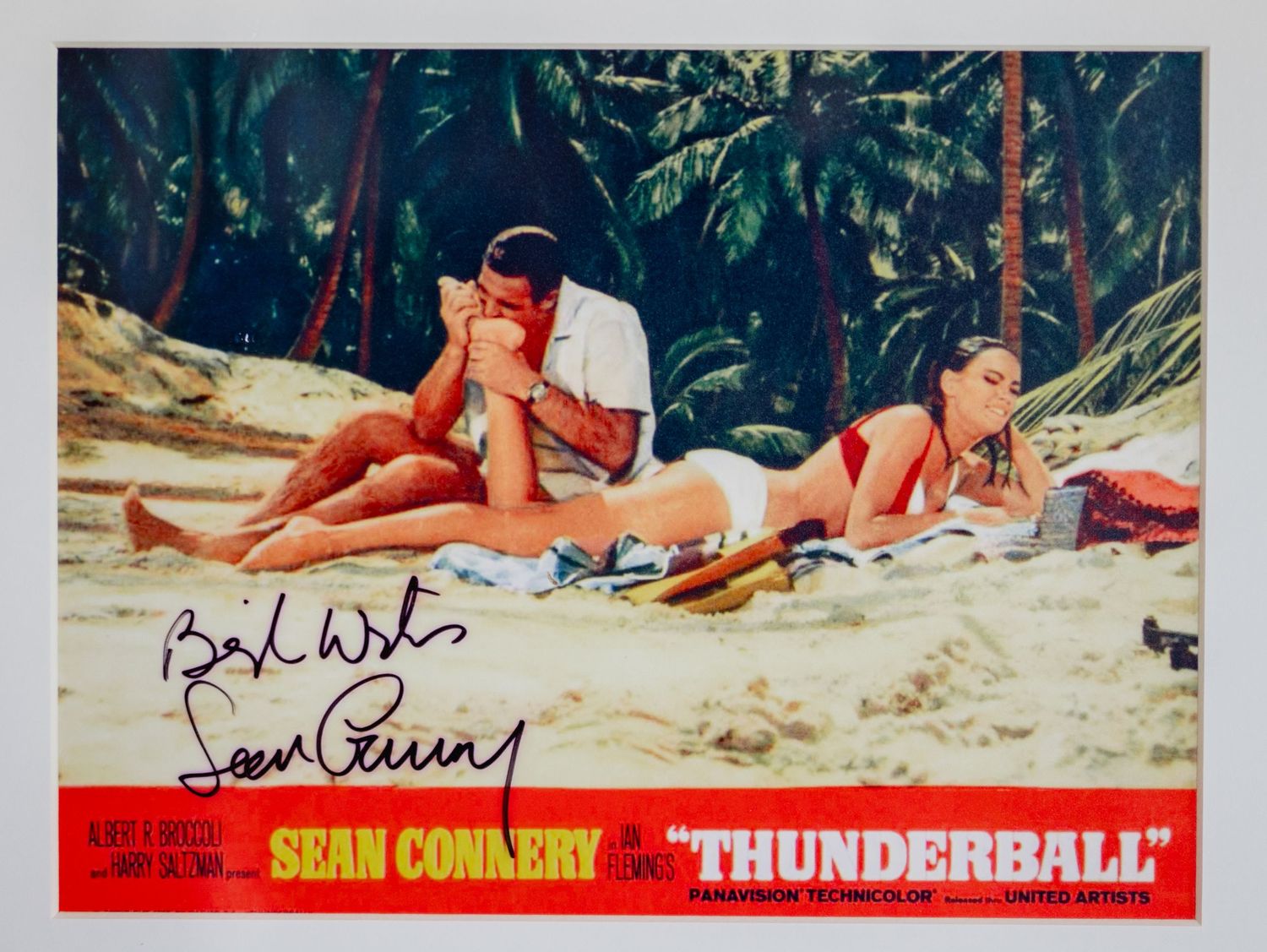 Vintage movie still from James Bond Thunderball showing beach scene with autograph.