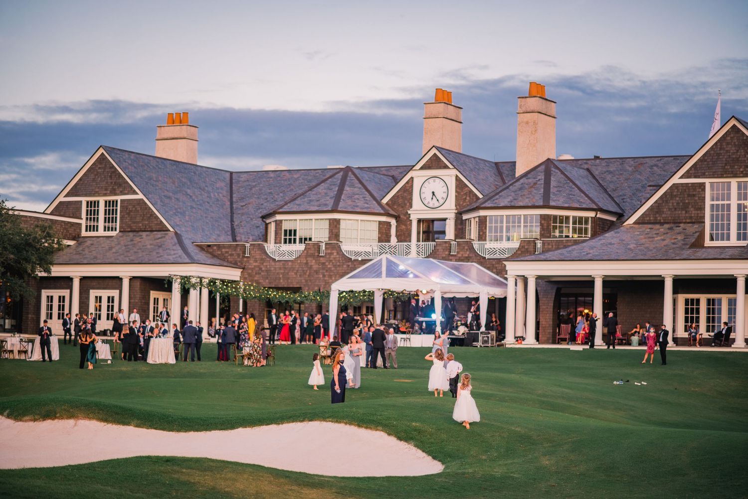 Scenic golf course with clubhouse buildings and bunkers at sunset, showing multiple views of the property.
