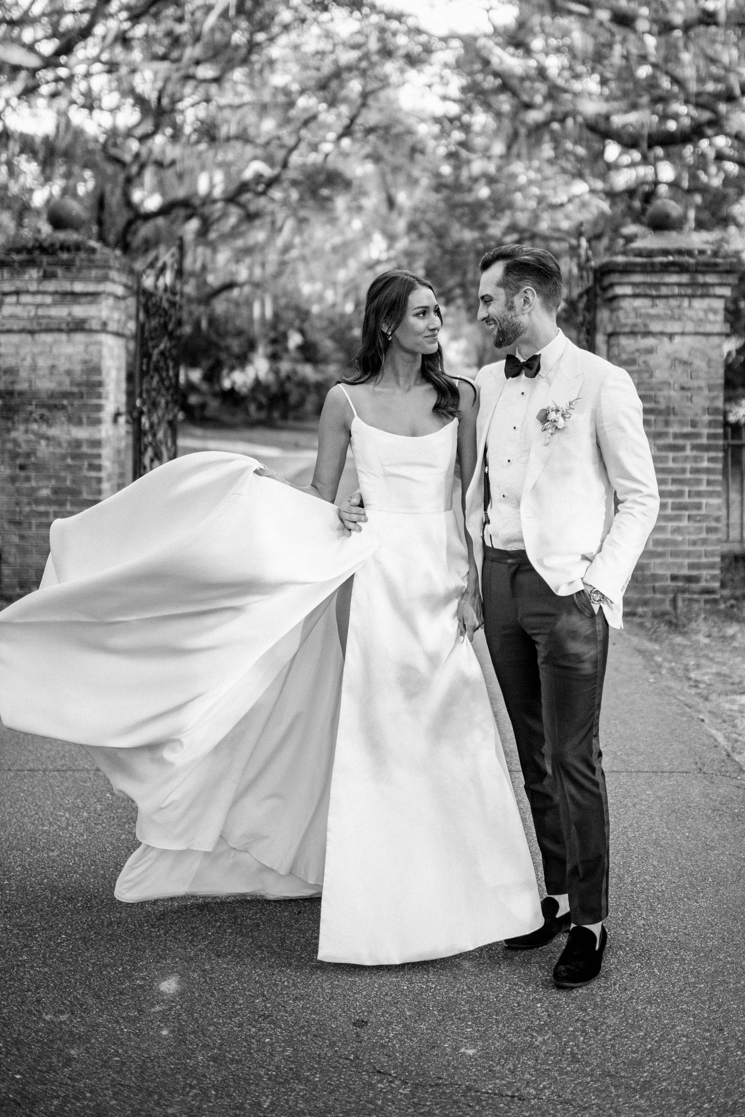 Black and white romantic wedding portraits with flowing dress movement.