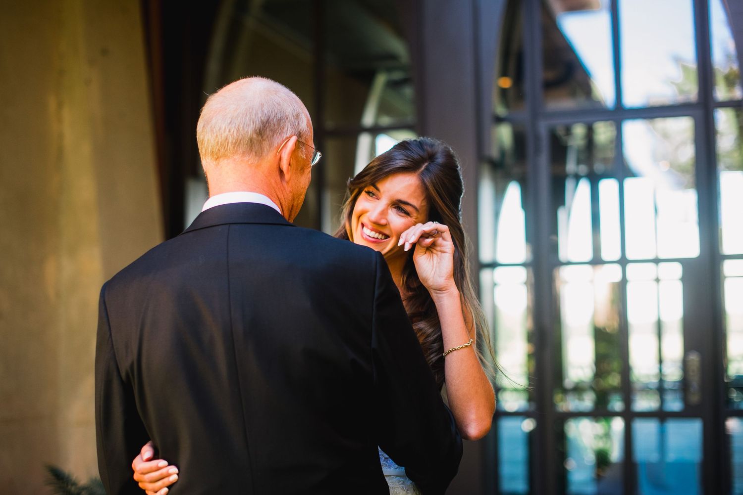Couples sharing intimate moments and dancing during a romantic wedding celebration in an elegant indoor venue.