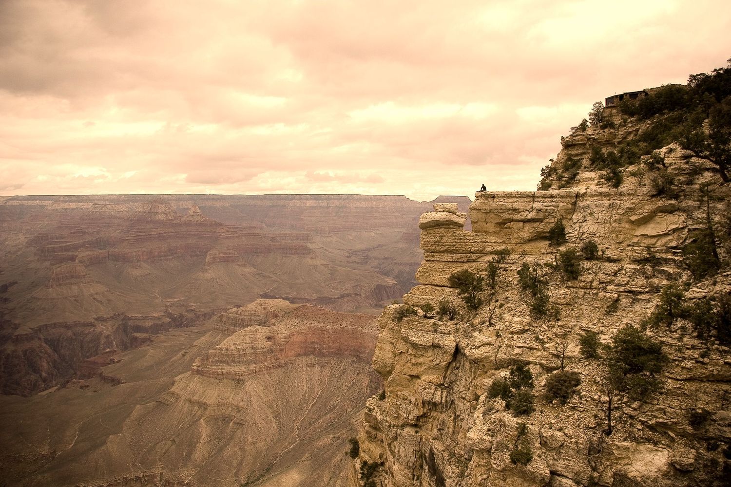 Panoramic view of layered rock formations at Grand Canyon during sunset.