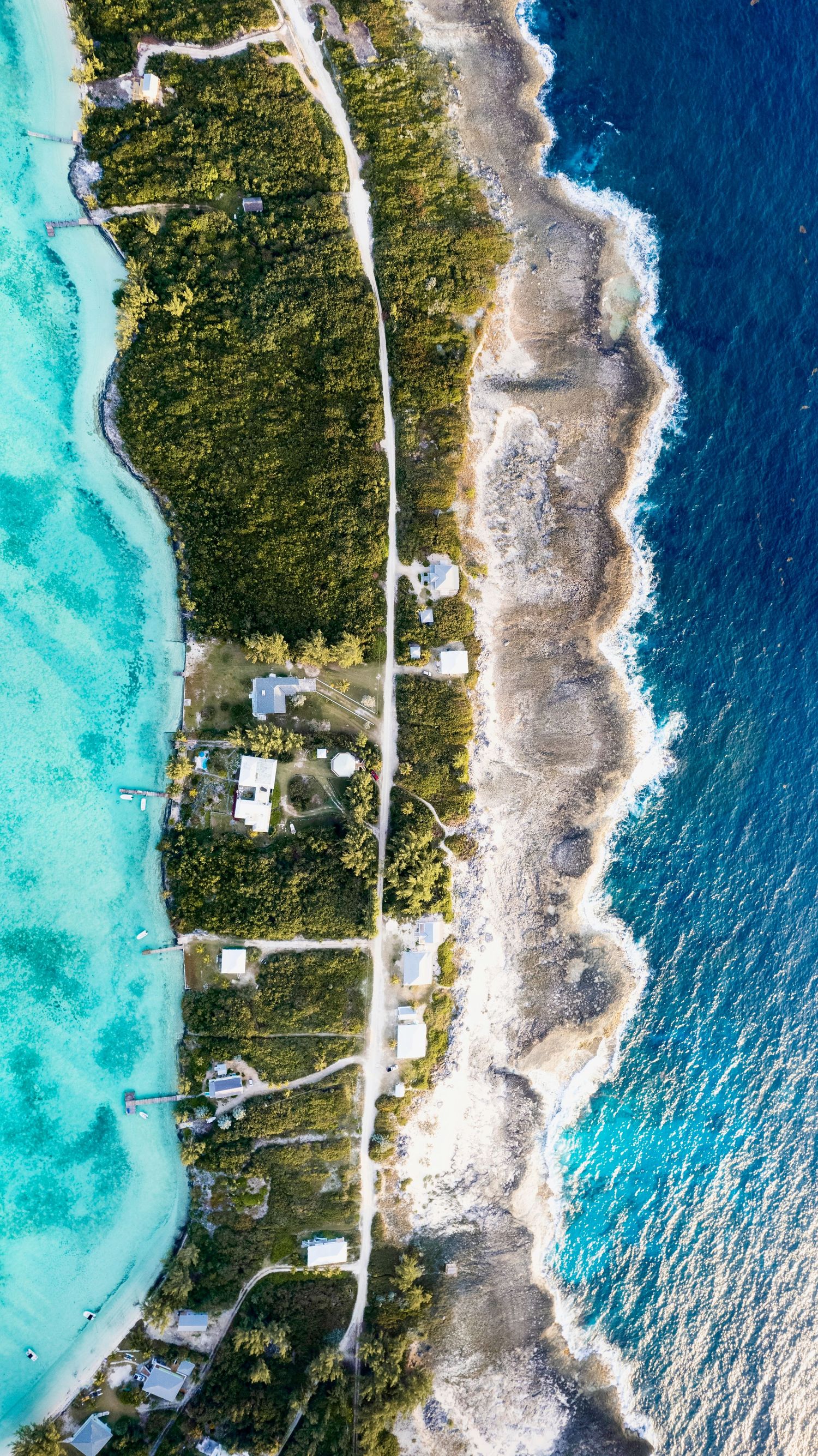 Aerial view of a Eleuthra shoreline with turquoise waters, white beaches and green vegetation stretching across multiple islands.