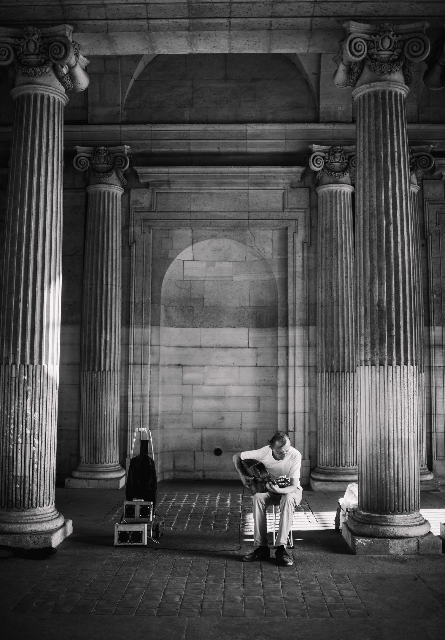 Classical stone columns in a dimly lit historic building interior.