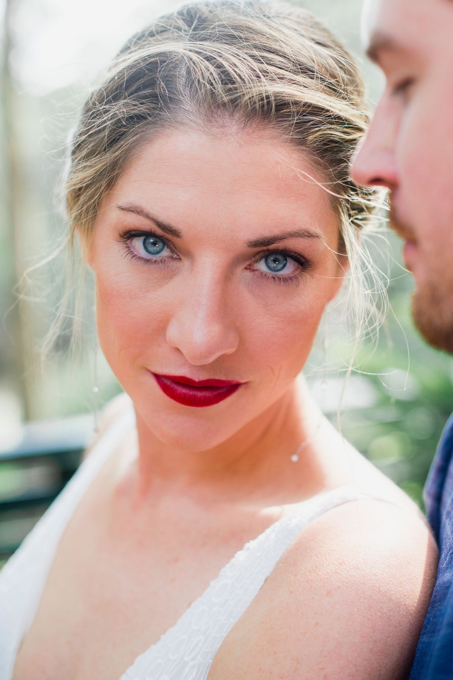 A series of close-up shots showing bright blue eyes and red lipstick in varying expressions.