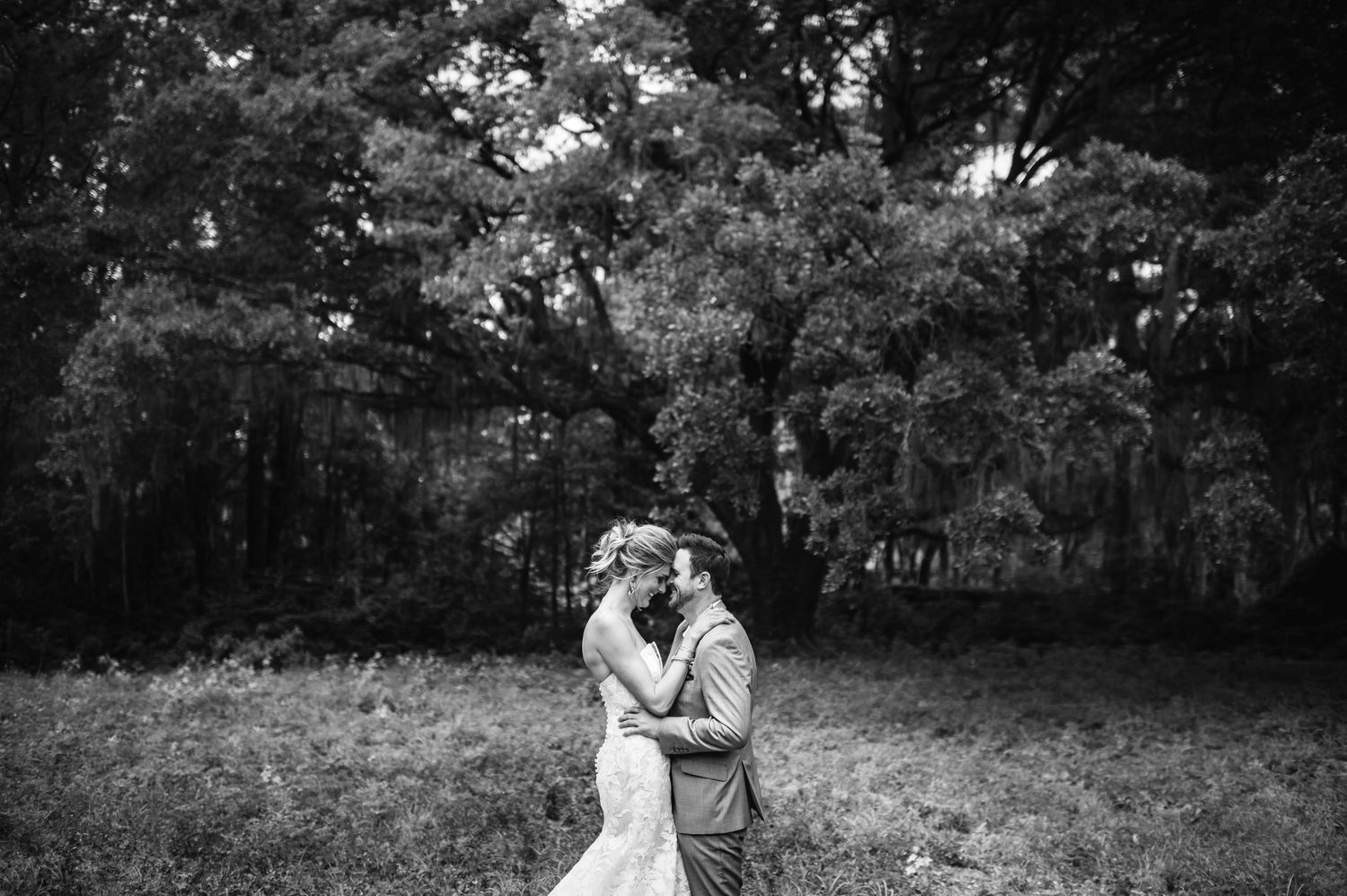 A series of black and white wedding photos showing romantic moments between a couple in an outdoor garden setting.