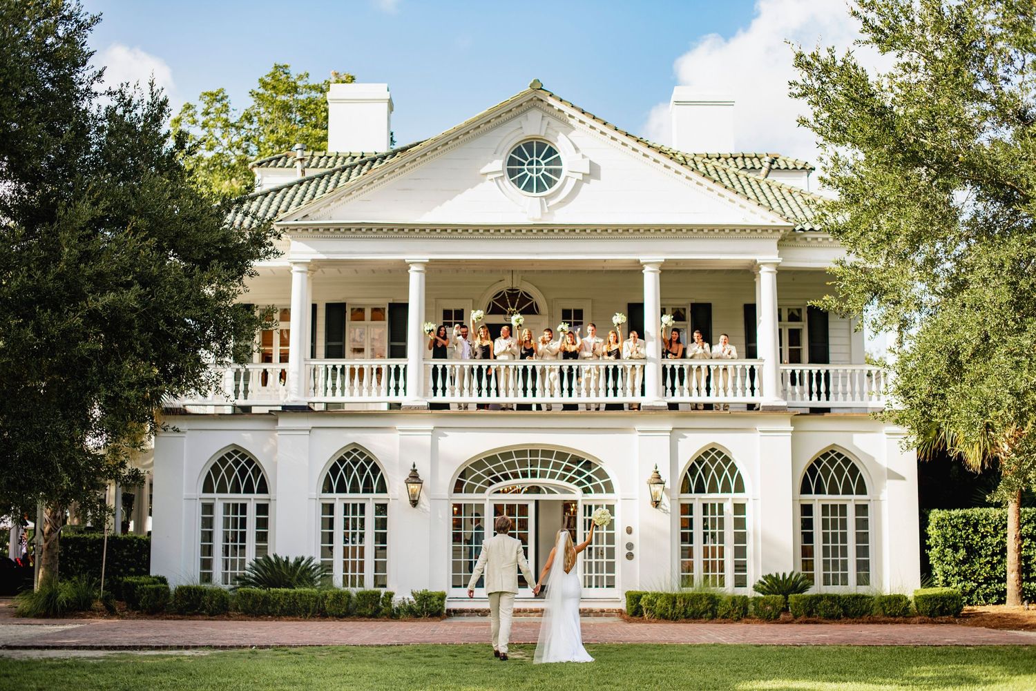 Elegant white southern mansion with wrap-around porch and columns features multiple views of its grand exterior architecture.