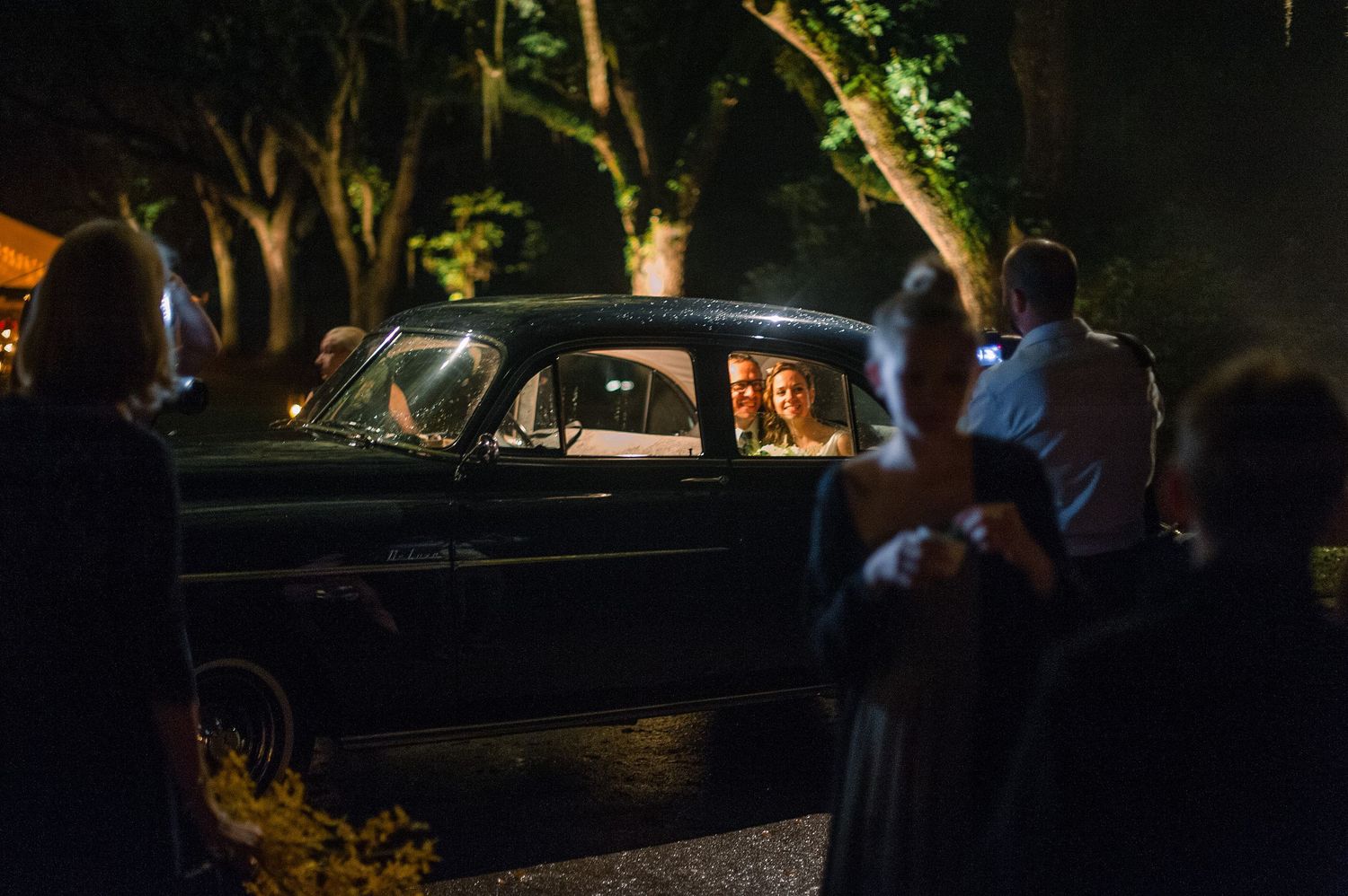 A series of dimly lit nighttime photos showing cars and people gathered in a dark outdoor setting.