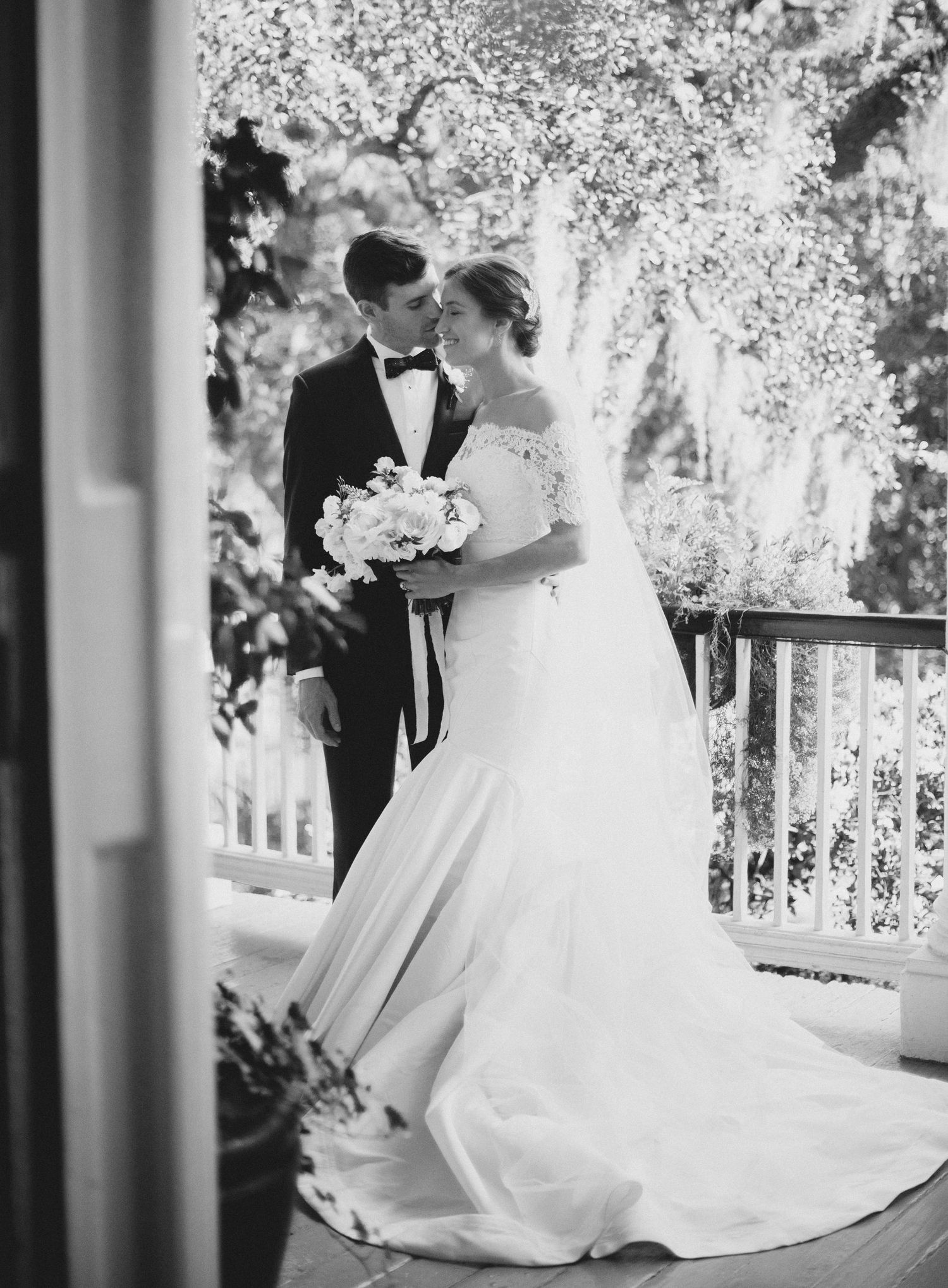 Black and white wedding photos showing elegant bride in flowing gown on outdoor porch with romantic lighting.