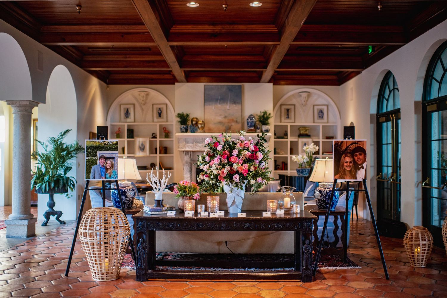 Interior panoramic view of an elegant wedding venue with stone walls and arched windows illuminated by warm lighting.