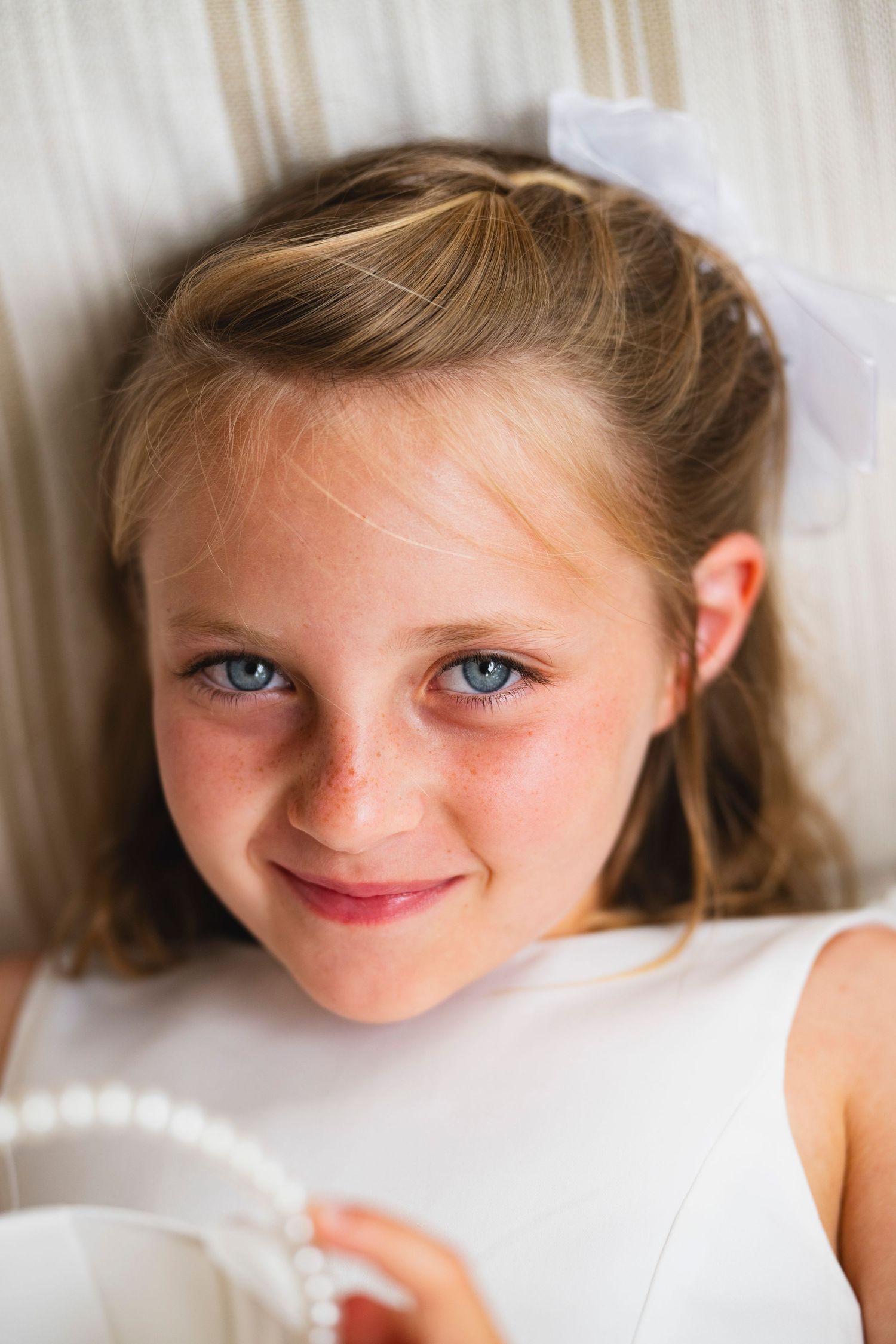 A series of four cropped portrait photos showing bright blue eyes and a gentle smile against a white background.