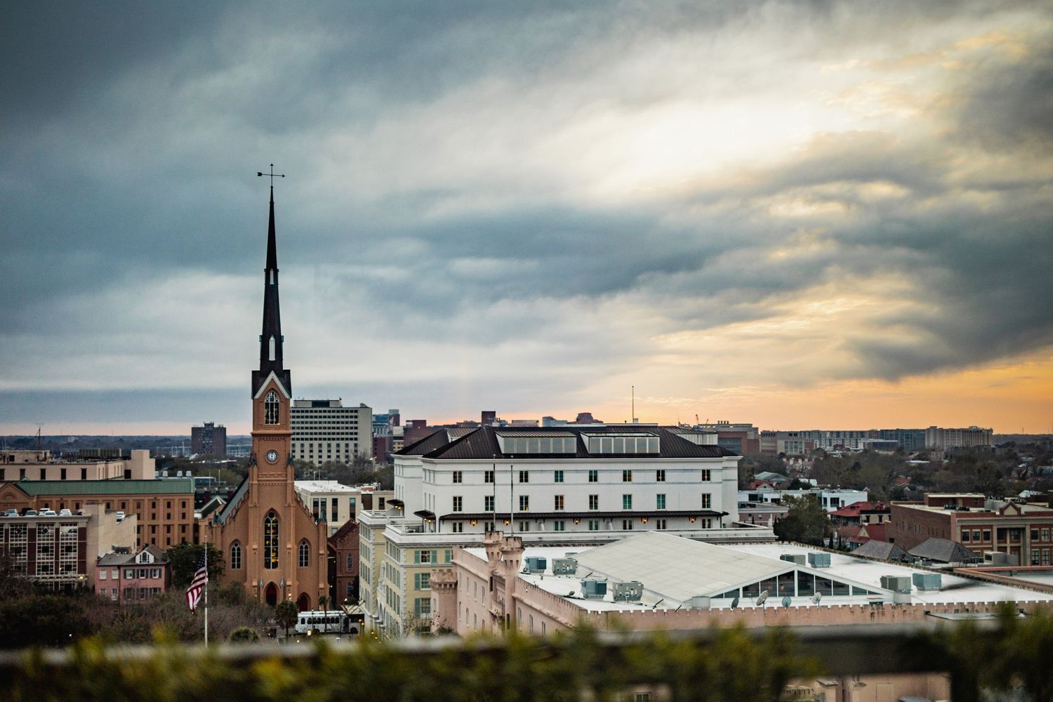Dramatic sunset sky over historic church spire and cityscape buildings in downtown Moncton, New Brunswick.