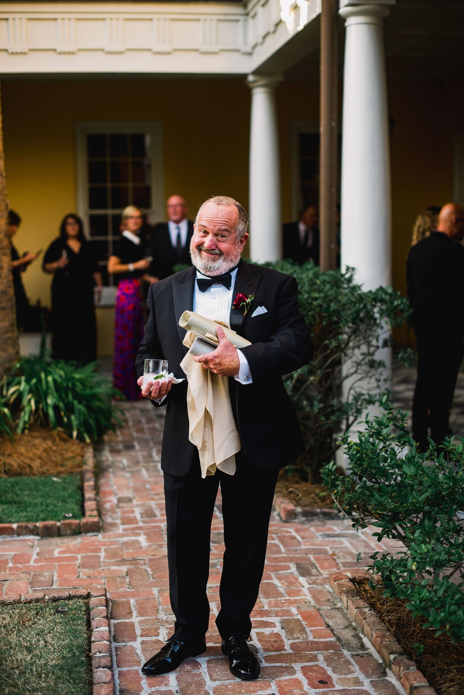 A sequence of photos showing a person in formal attire bending down to pick up something from a brick patio.